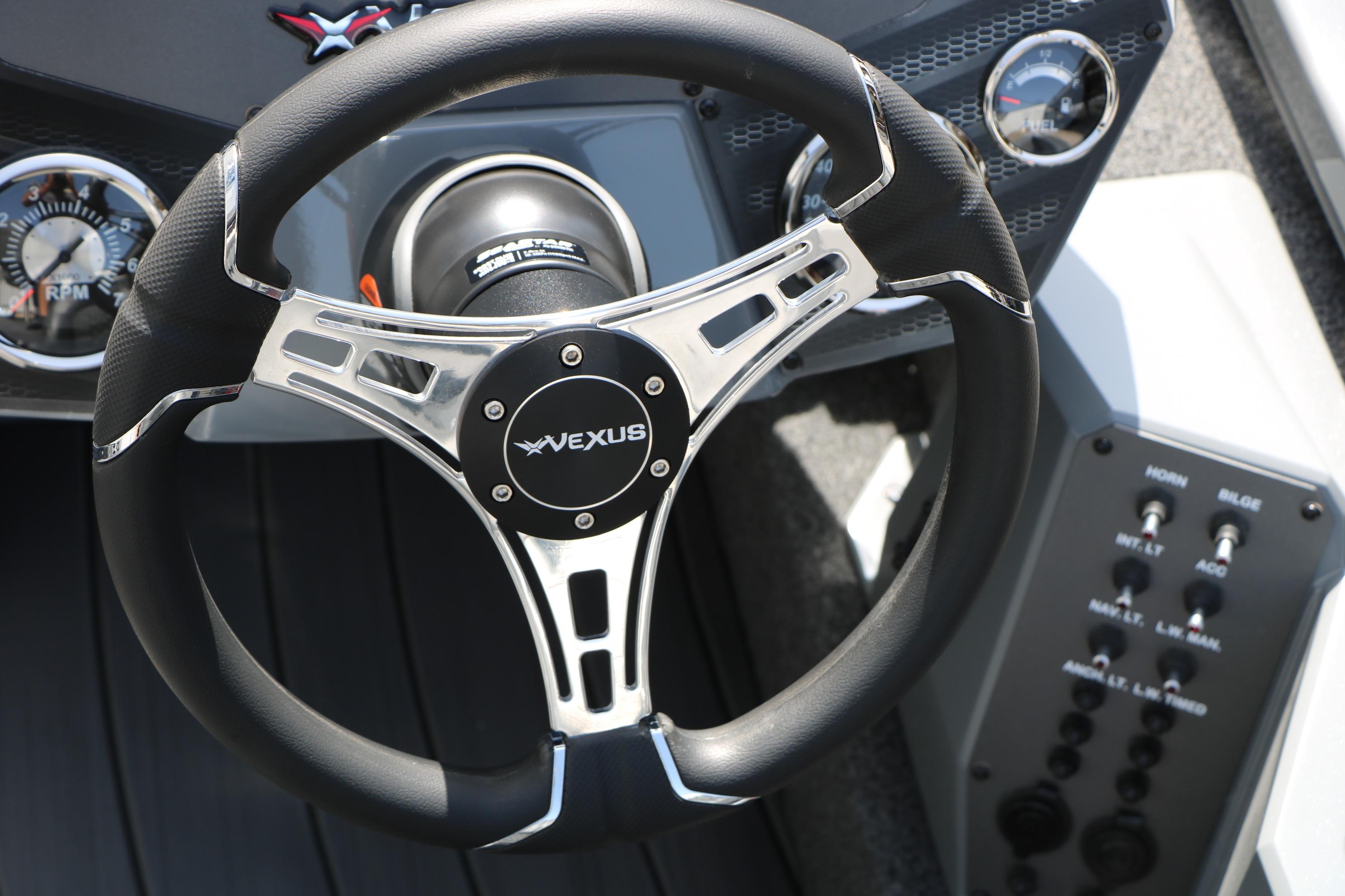 Steering wheel of 2026 Vexus AVX1980 boat with control panel and gauges.