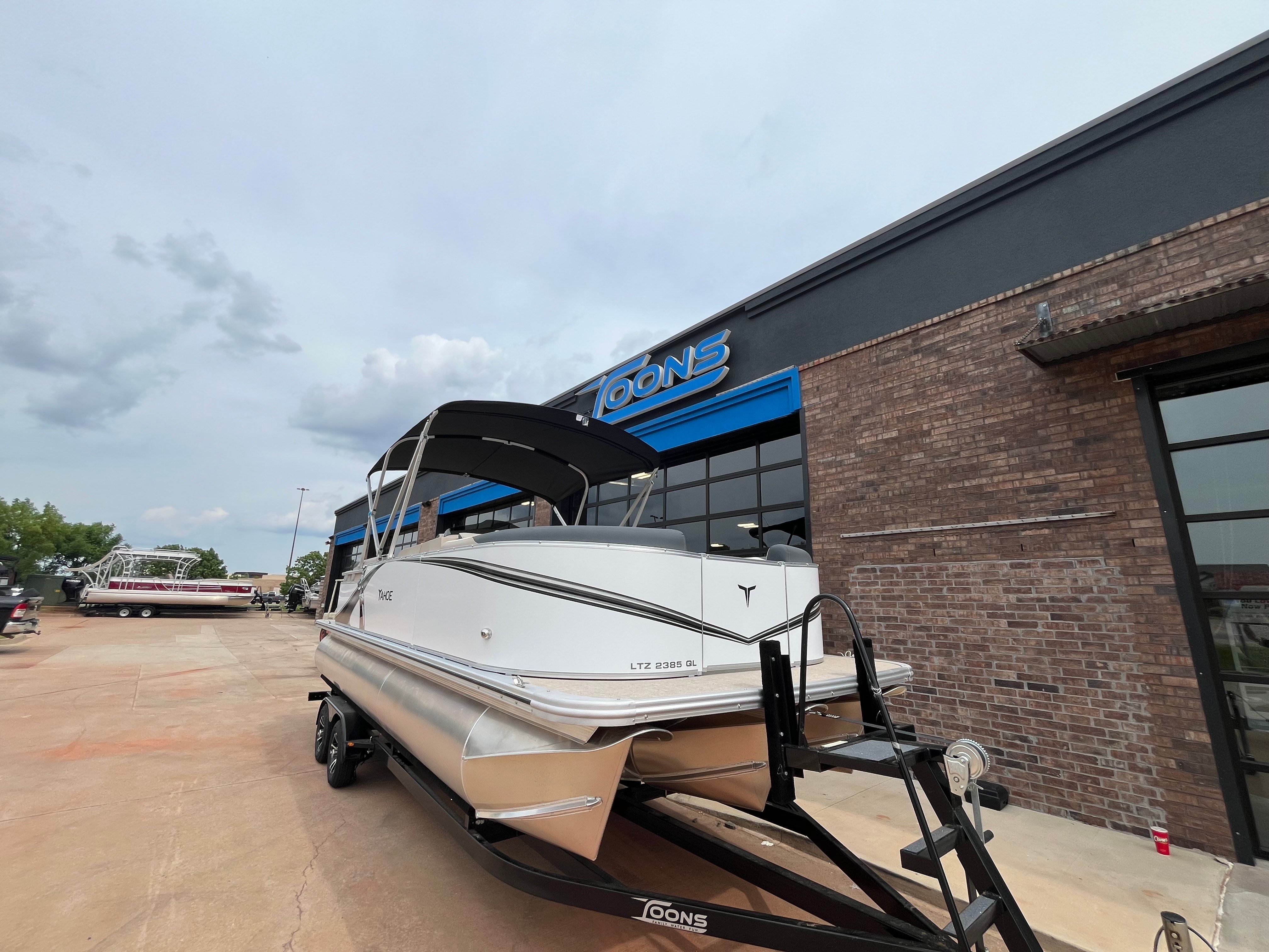 2025 Tahoe LTZ QL pontoon boat outside a store.