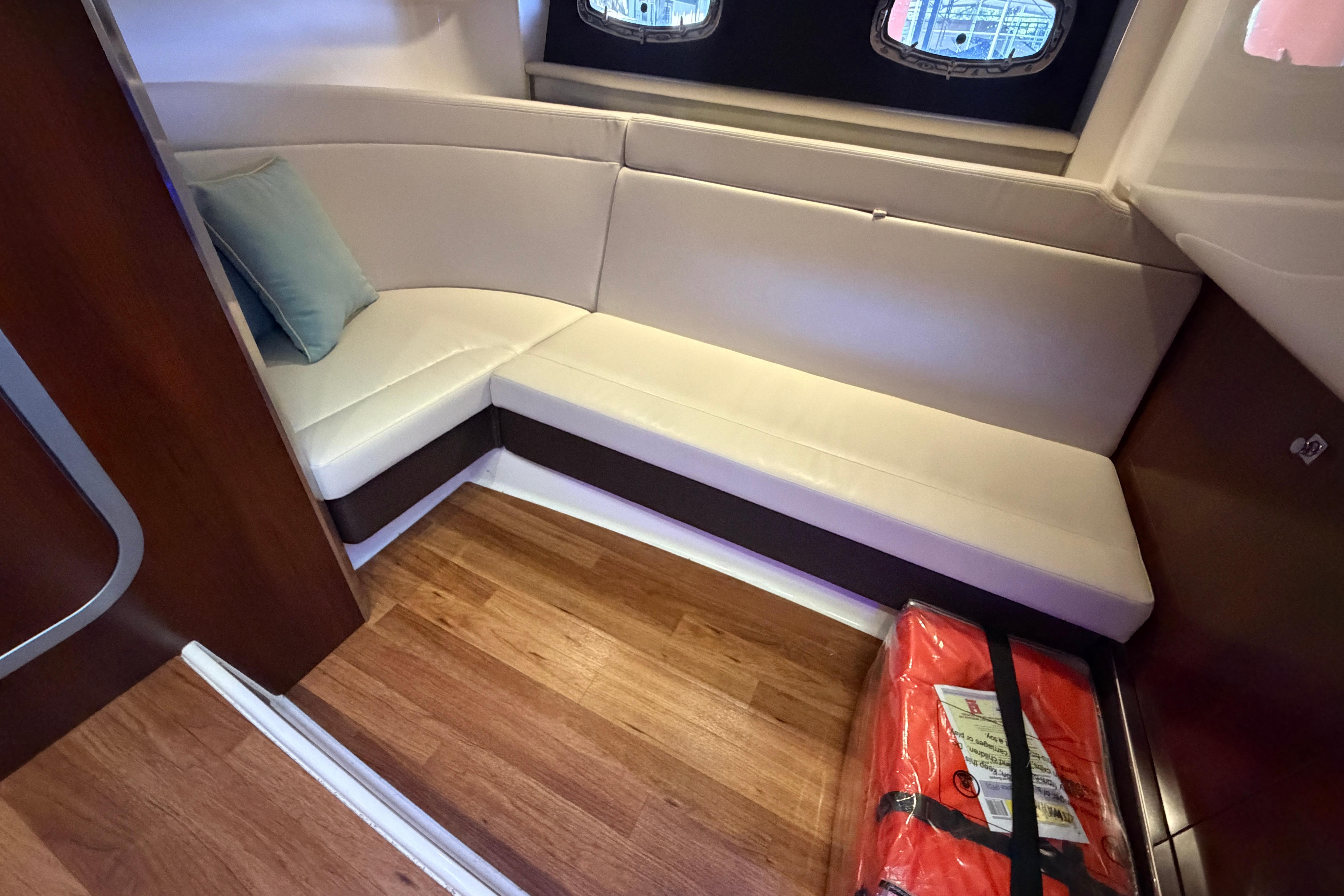 2018 Chaparral 347 SSX interior with white seating and wooden flooring.