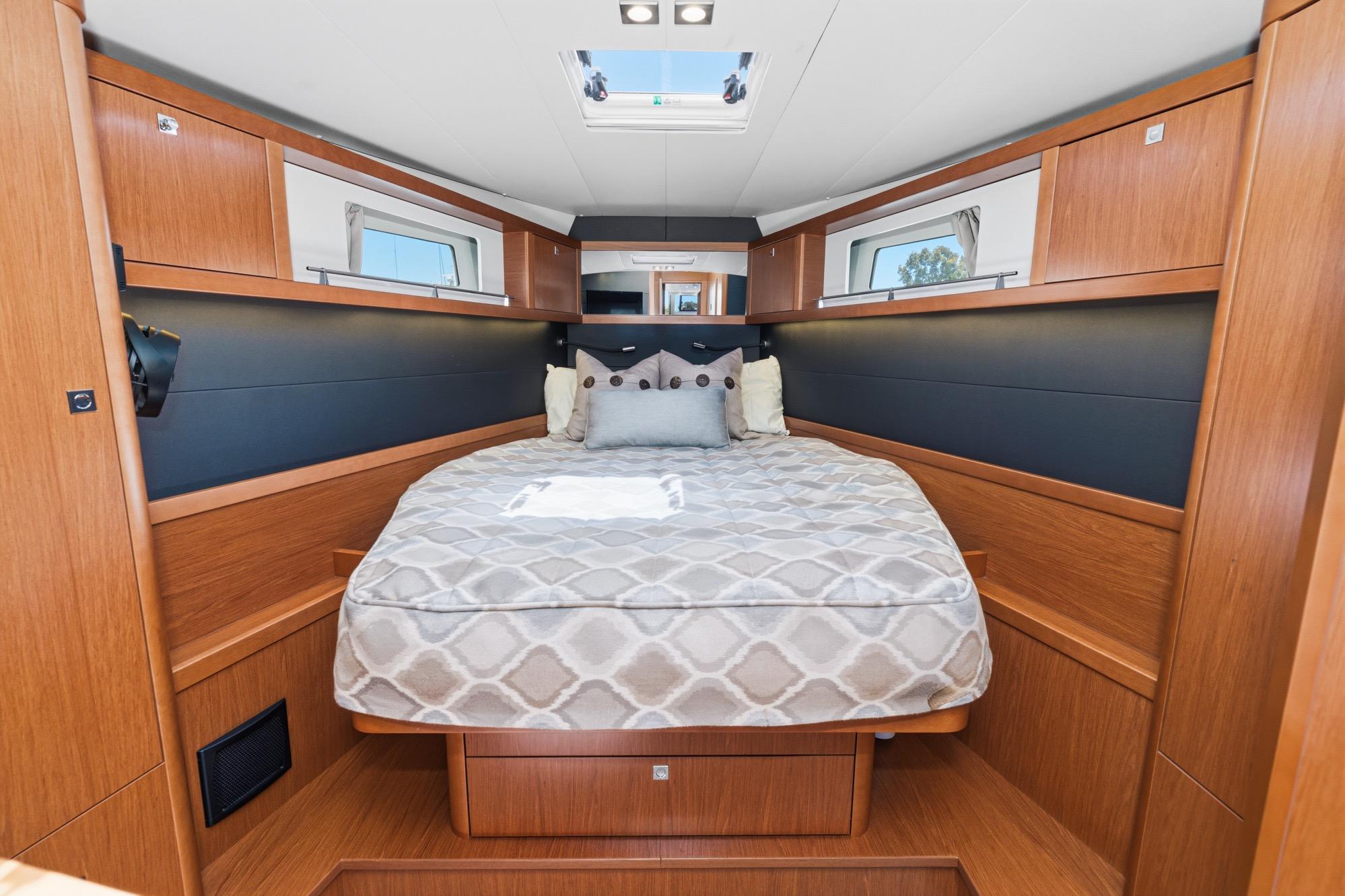 Luxurious cabin interior of 2017 Beneteau Sense 50 yacht with cozy bedding.