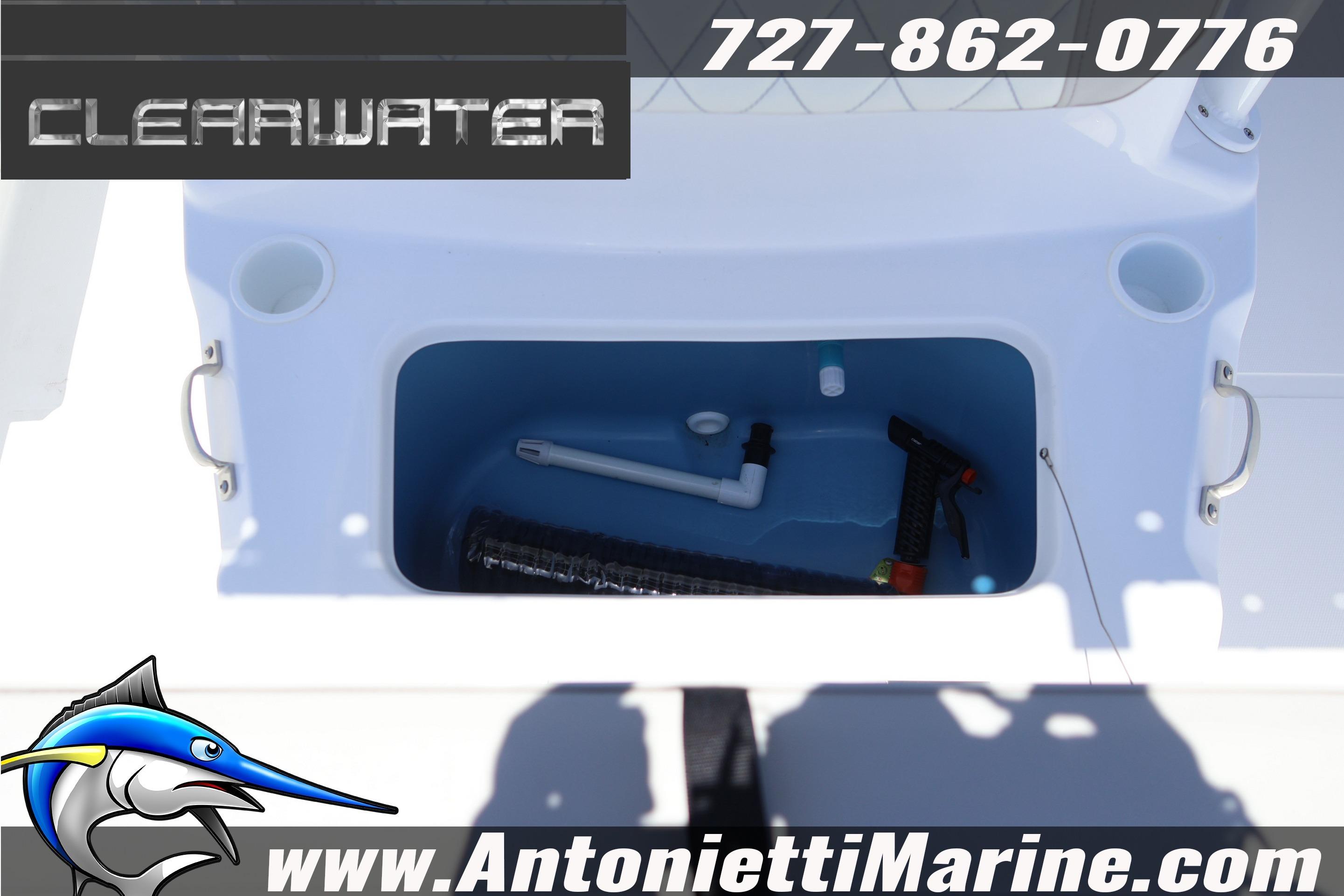 Open storage compartment on 2026 Clearwater 2000 Center Console boat, featuring marine equipment.