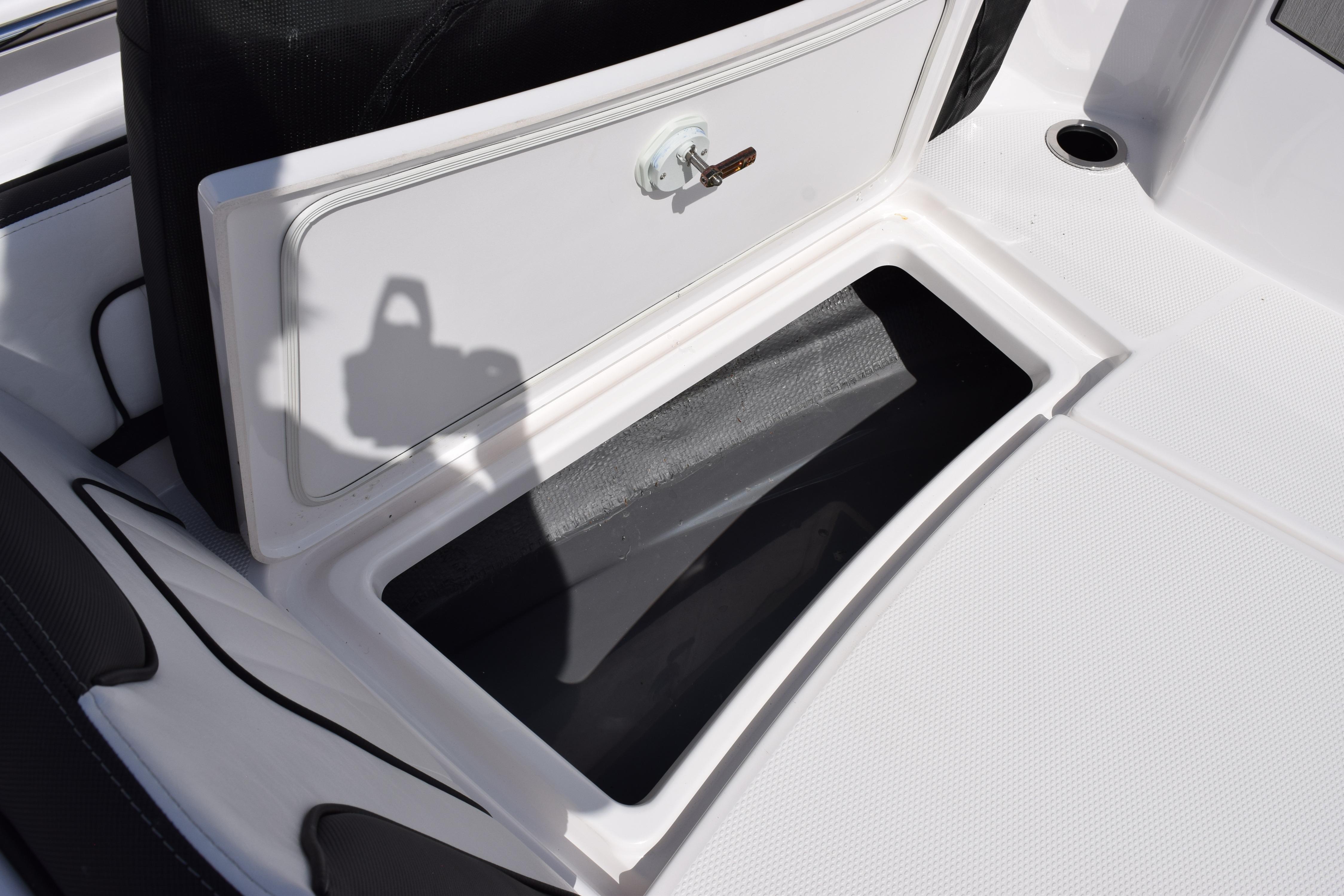 Open storage compartment on 2026 Yamaha Boats 255 FSH Sport H, featuring sleek design and secure latch.