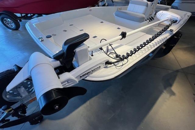 2026 Mako Pro Skiff 15 CC boat with trolling motor in showroom.