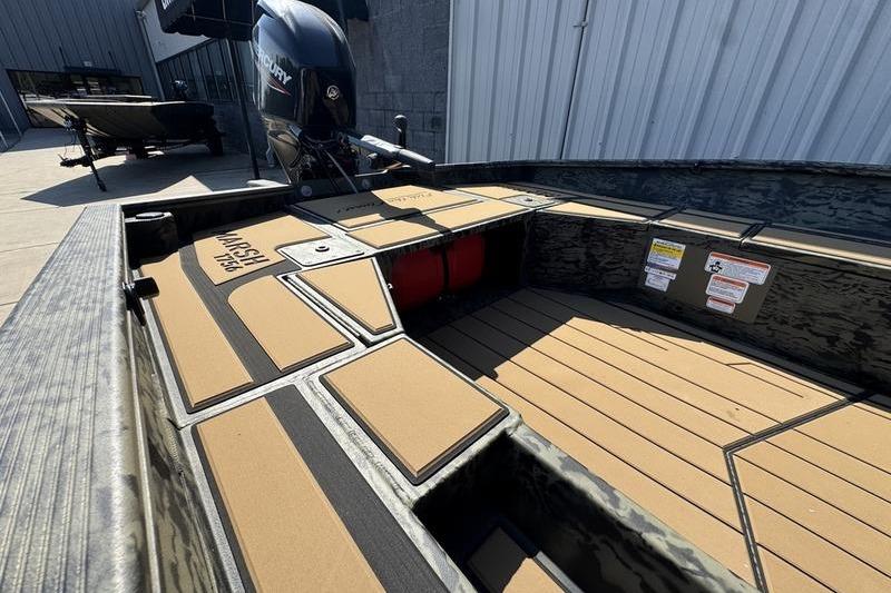 2026 Tracker Grizzly 1756 T Marsh boat interior with Mercury engine, docked outdoors.