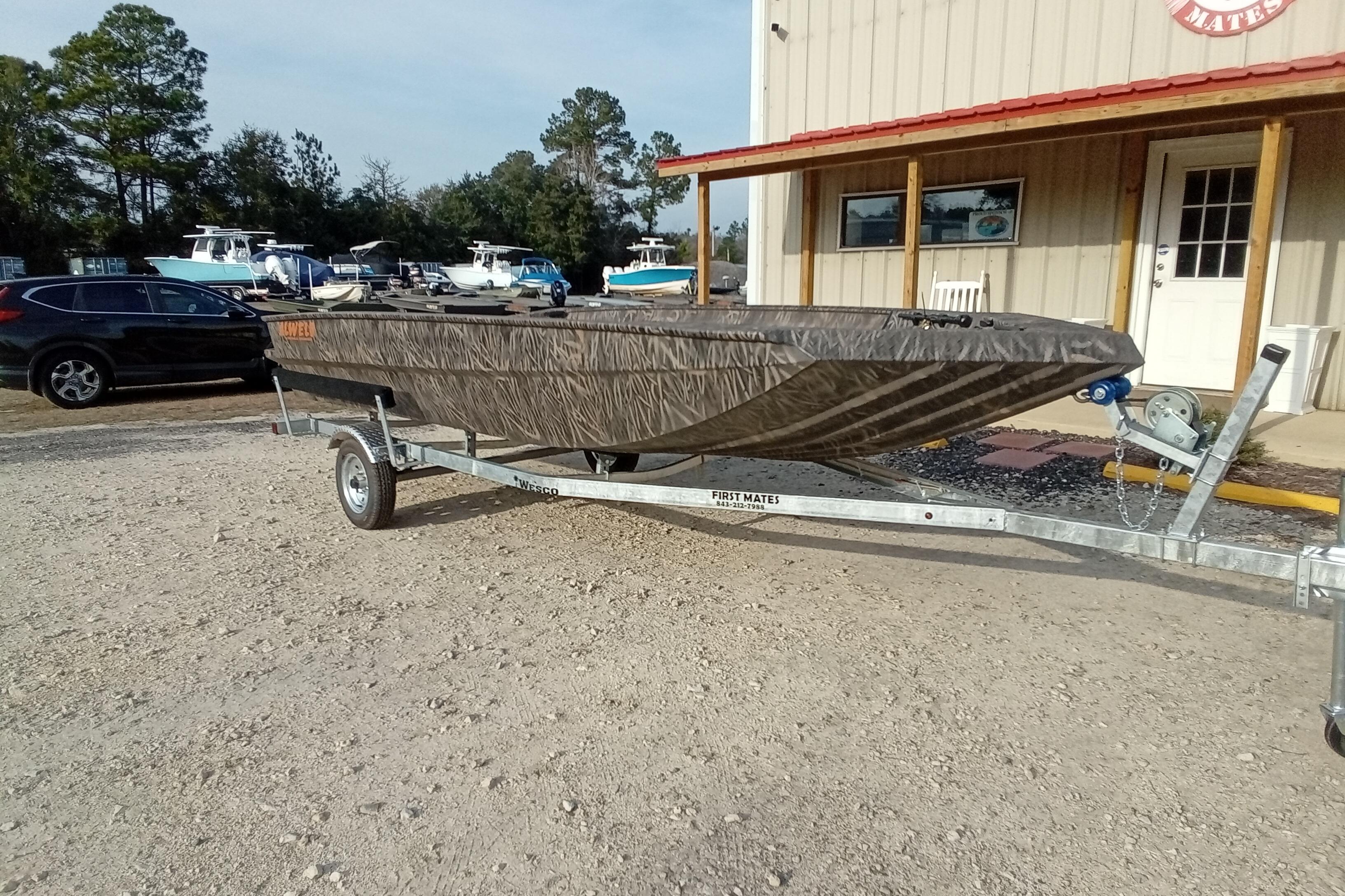 2026 Alweld 1756 Invader boat on trailer, parked outside a building.