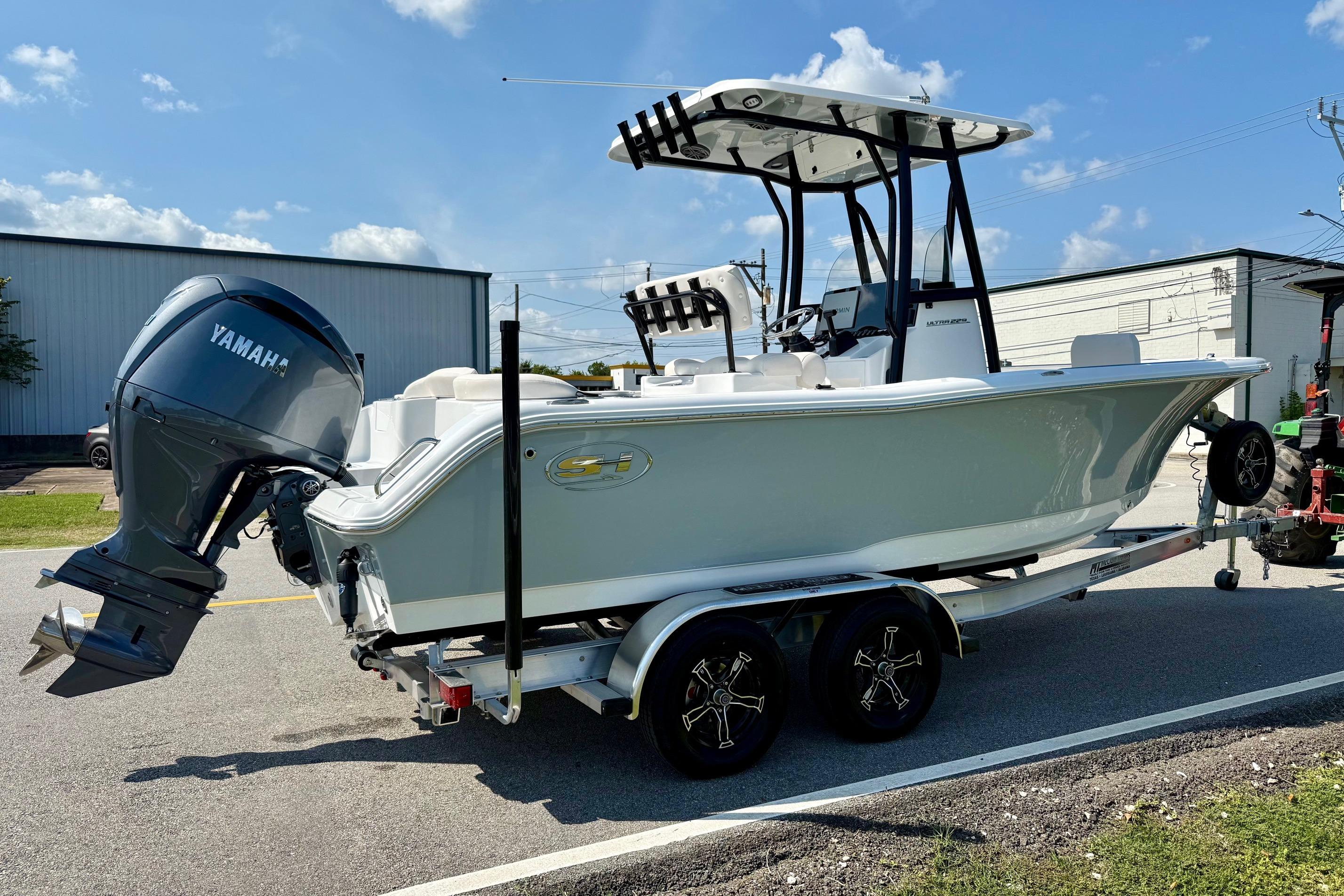 2026 Sea Hunt Ultra 229 boat on trailer with Yamaha outboard motor, parked outdoors.