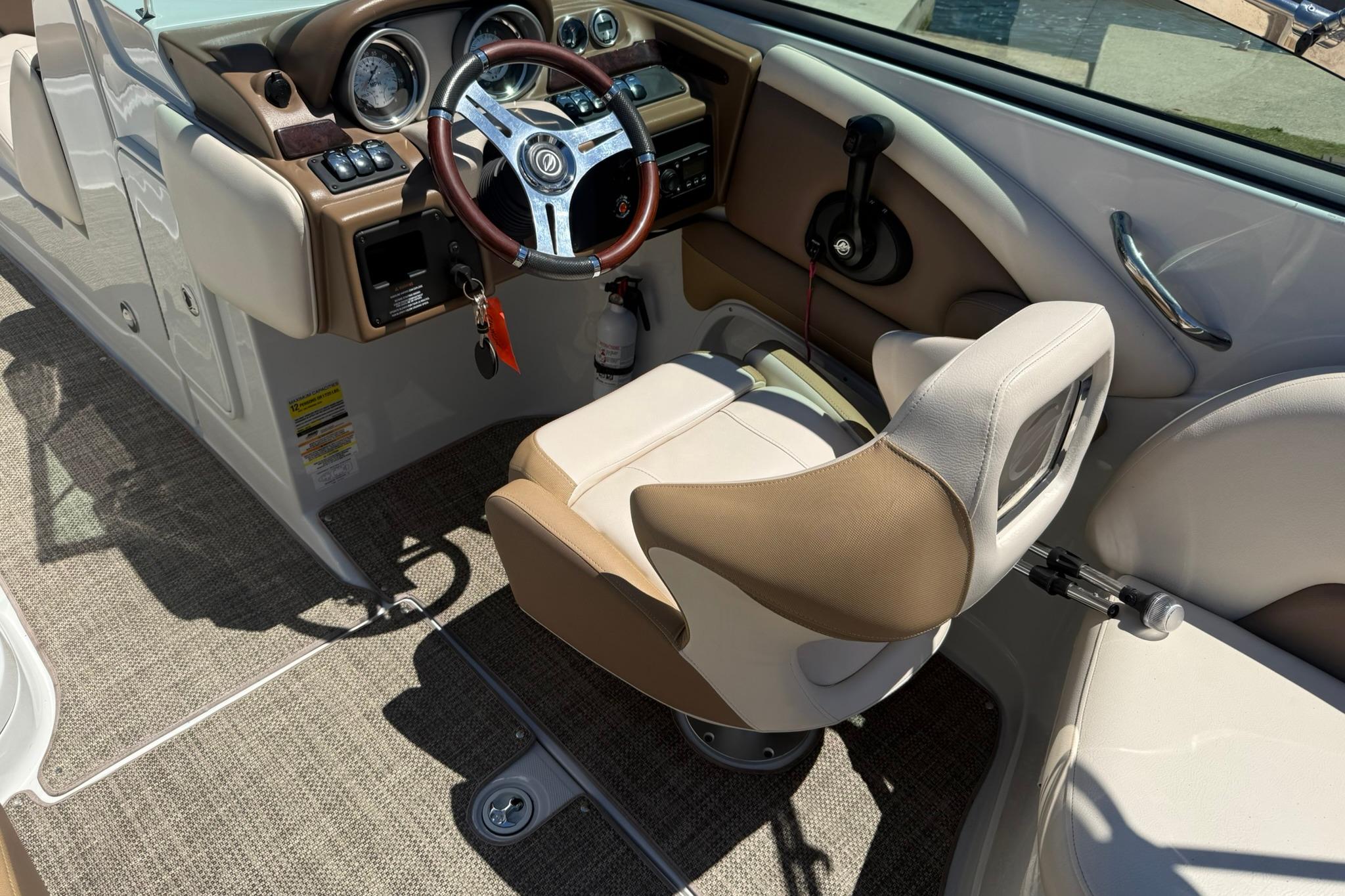 2016 Crownline 255 SS boat interior with steering wheel and captain's chair.