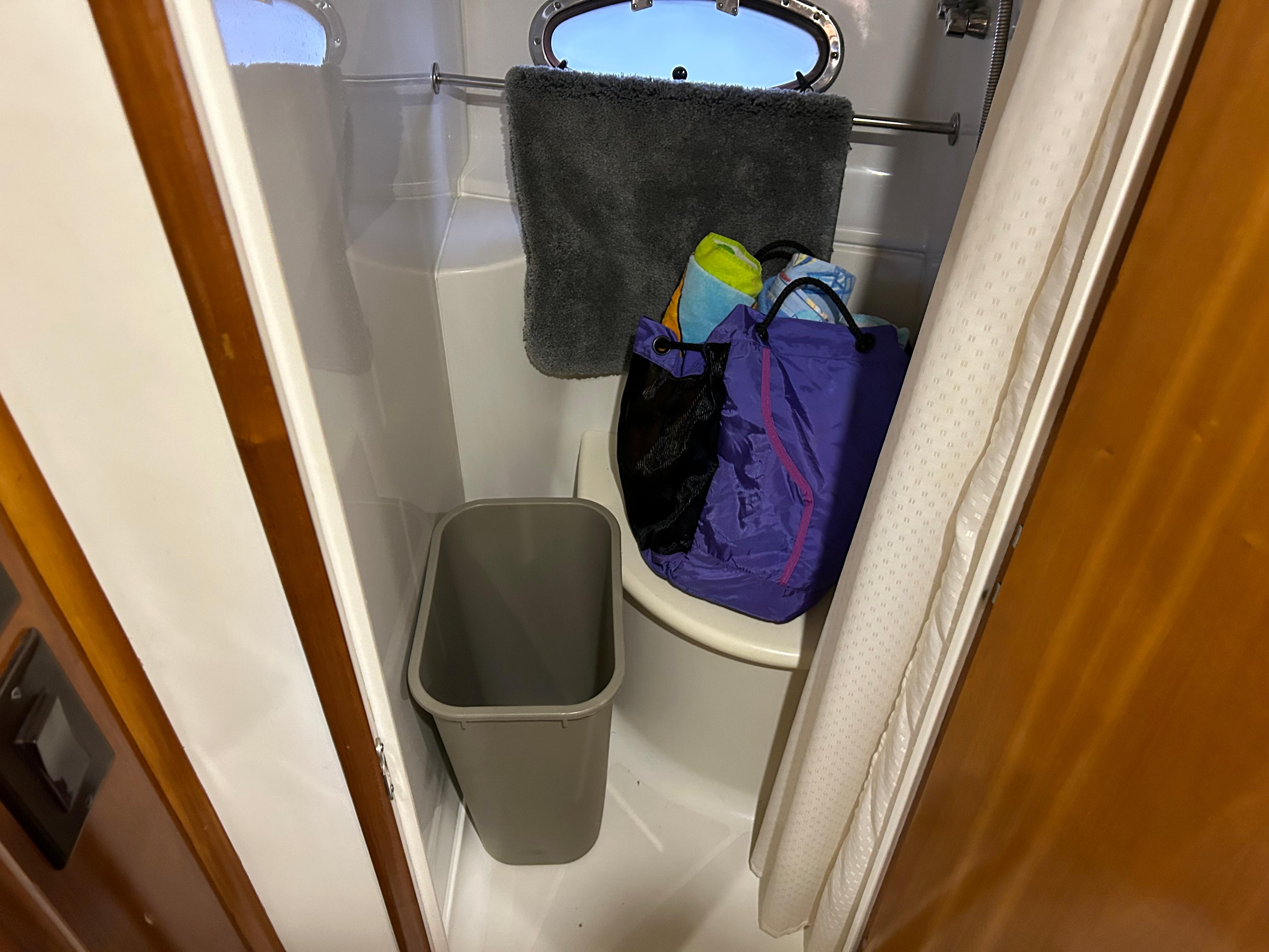 Small bathroom in 2000 Carver 396 yacht with bags and towel.