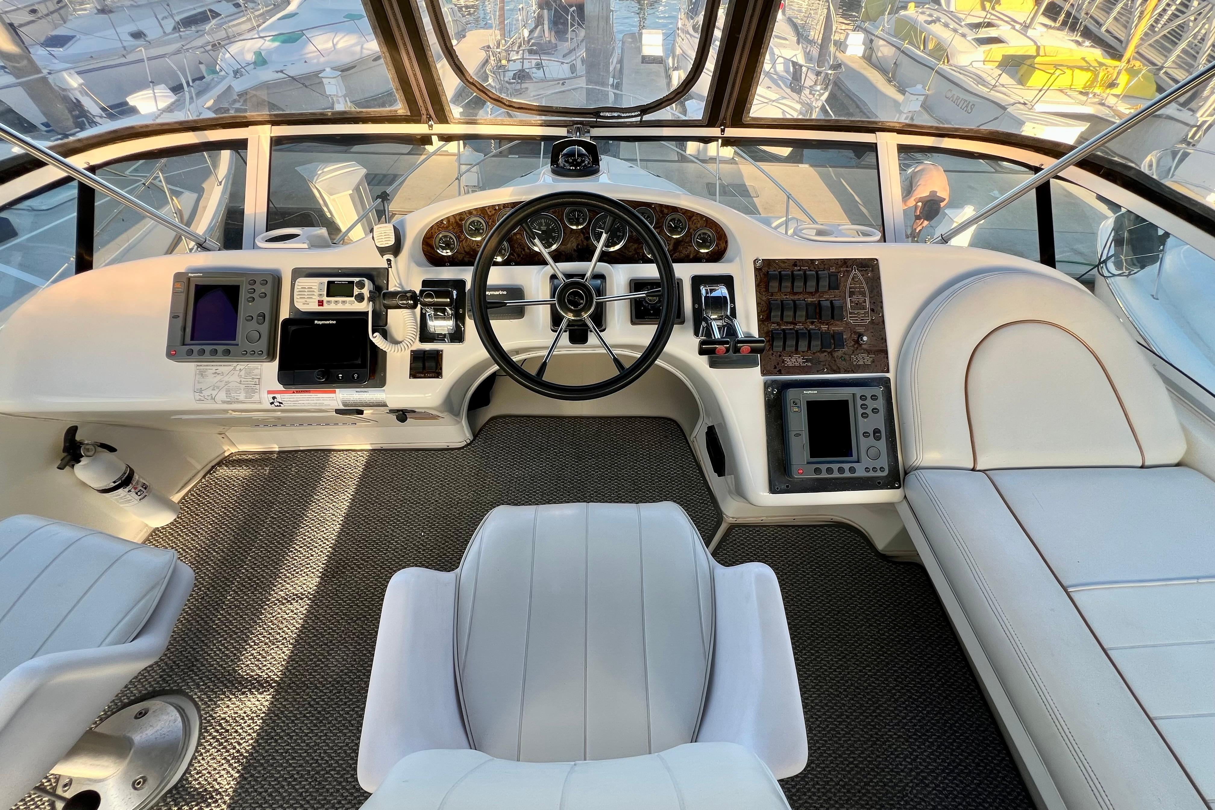 1997 Sea Ray 370 Aft Cabin helm with modern navigation equipment and comfortable seating.