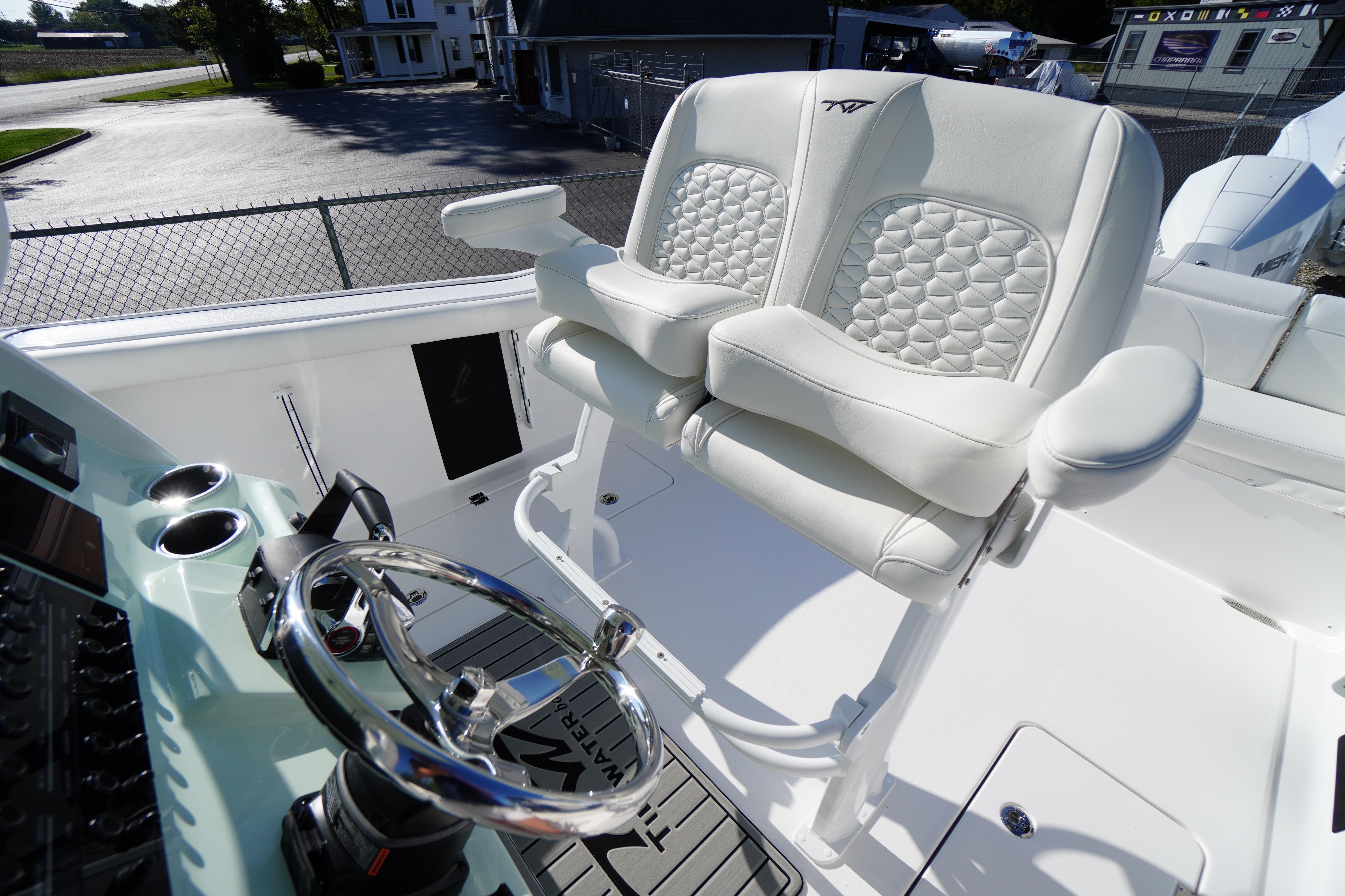 2026 Tidewater 272 LXF boat interior with luxurious white seating and modern steering console.