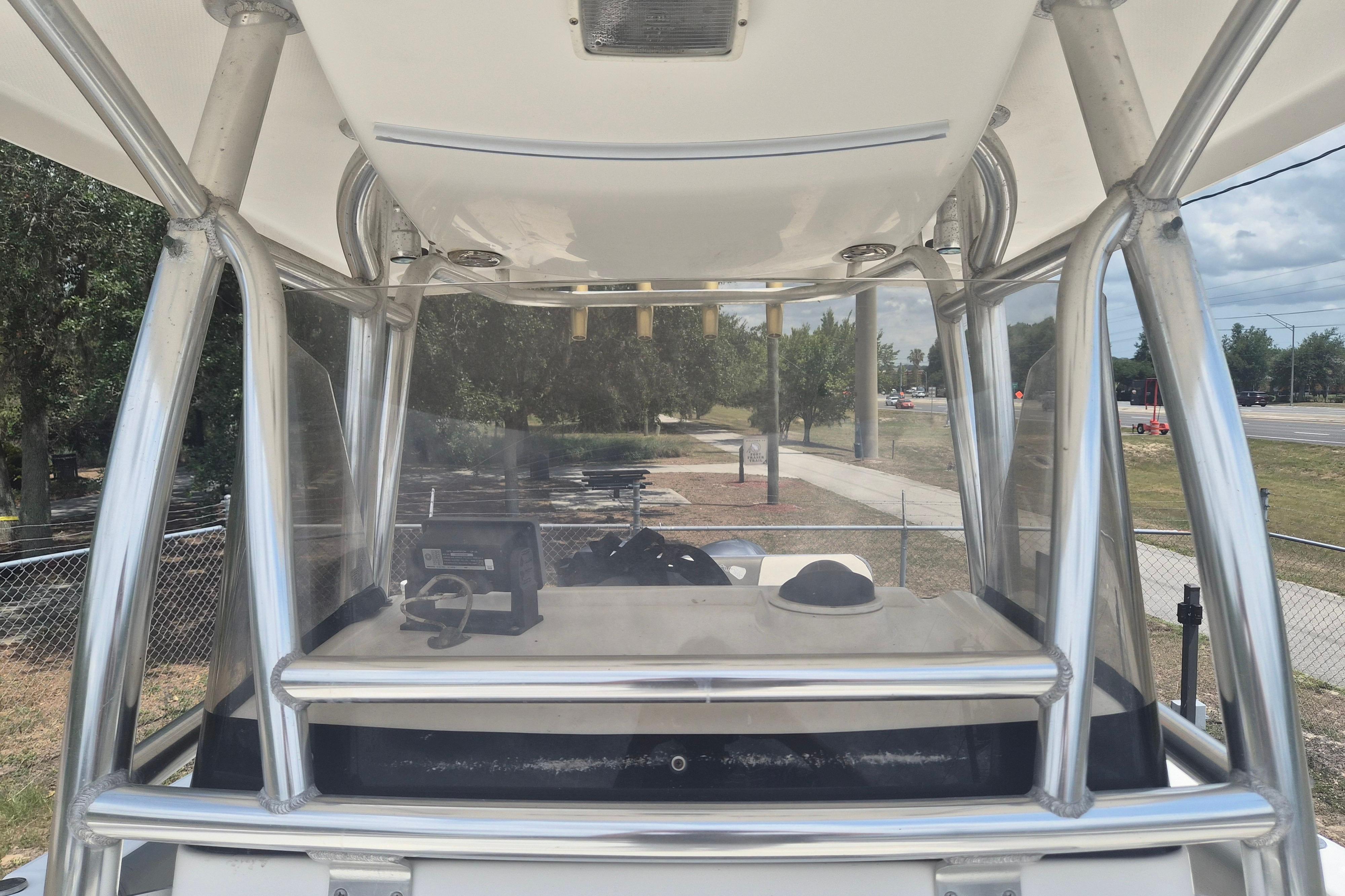 2006 Century 2900 Center Console boat with sturdy metal framework and clear windshield.