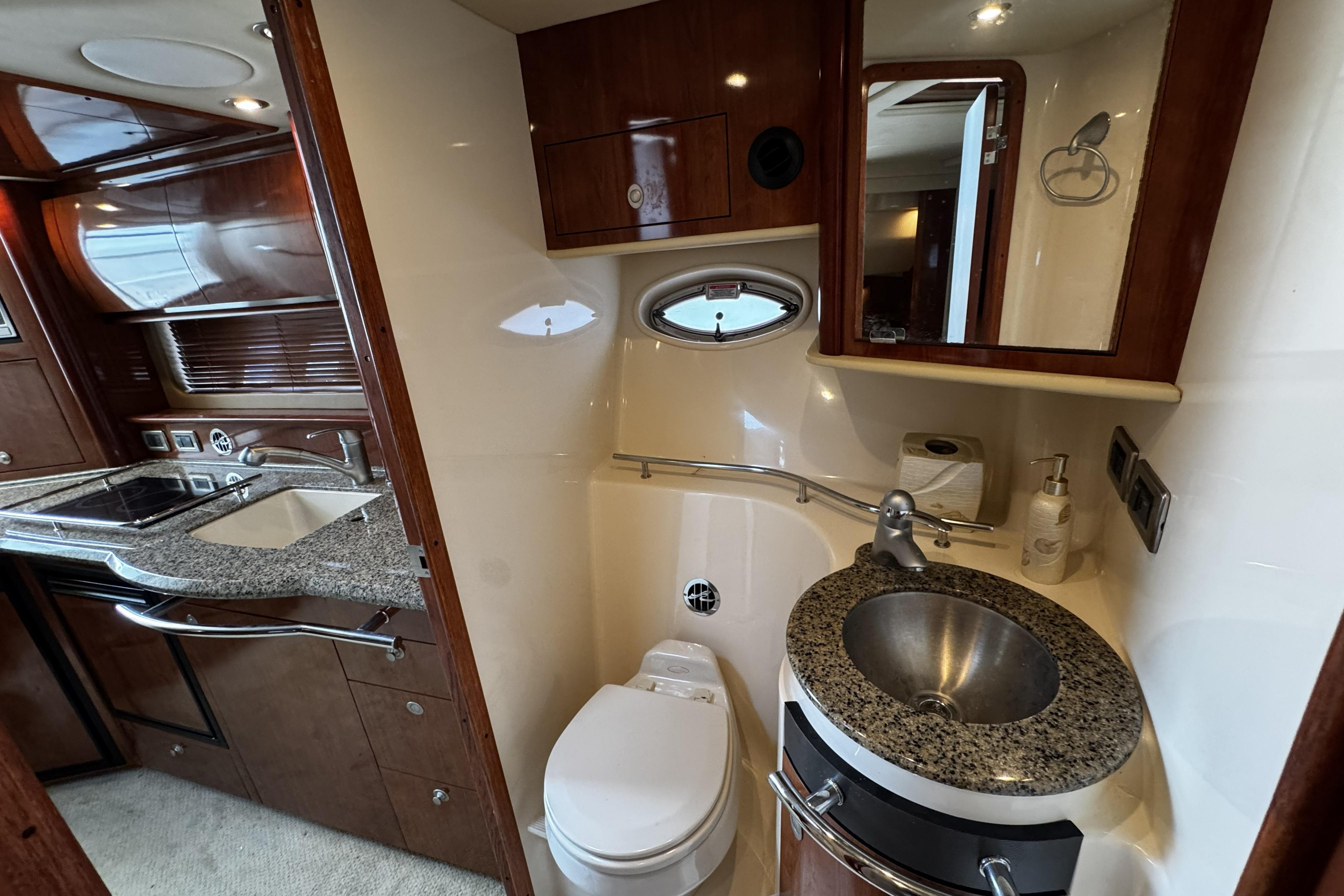 Luxurious 2006 Sea Ray 40 Sundancer yacht bathroom with granite countertops and modern fixtures.