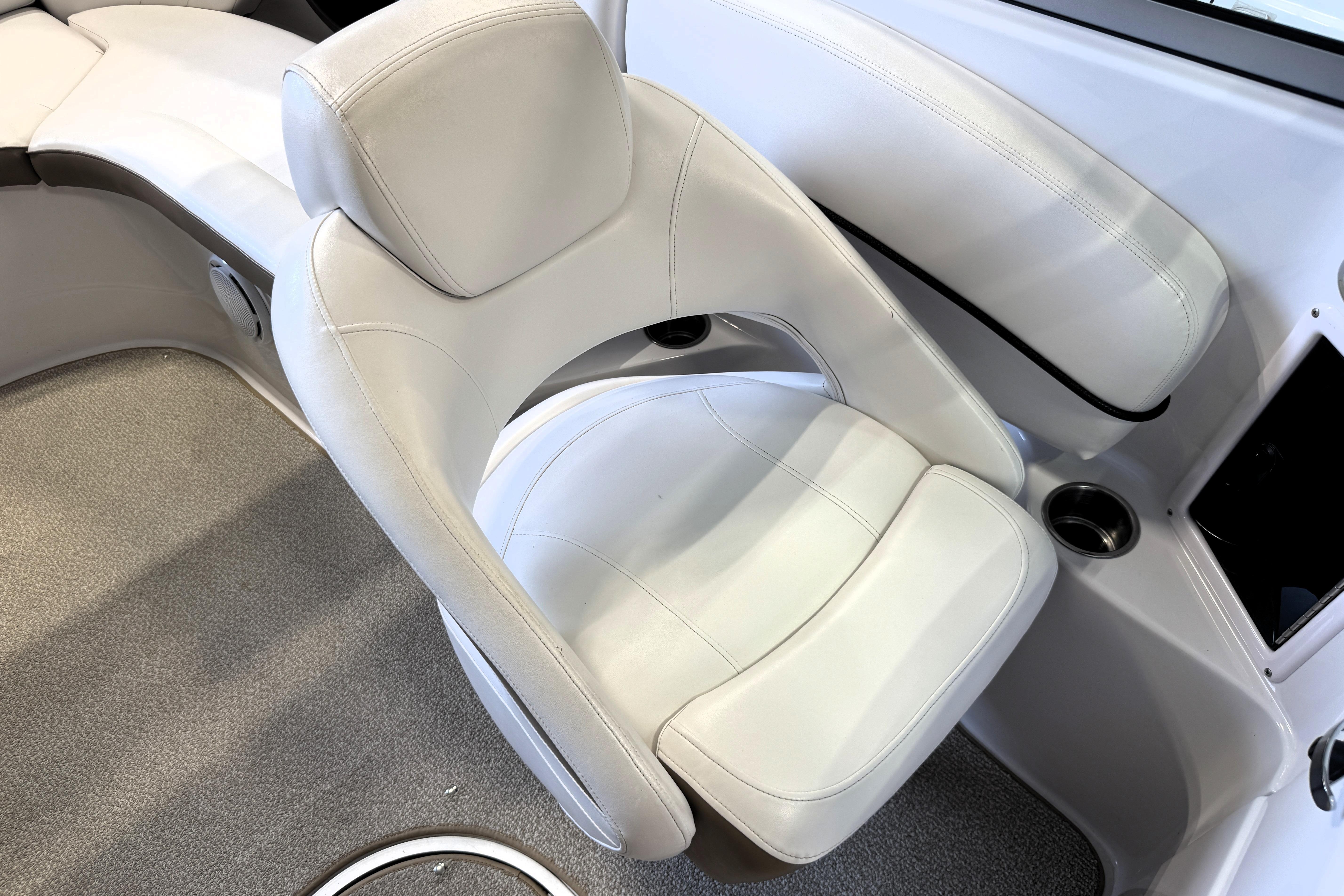 White leather seating in a 2008 Four Winns H240 boat interior.