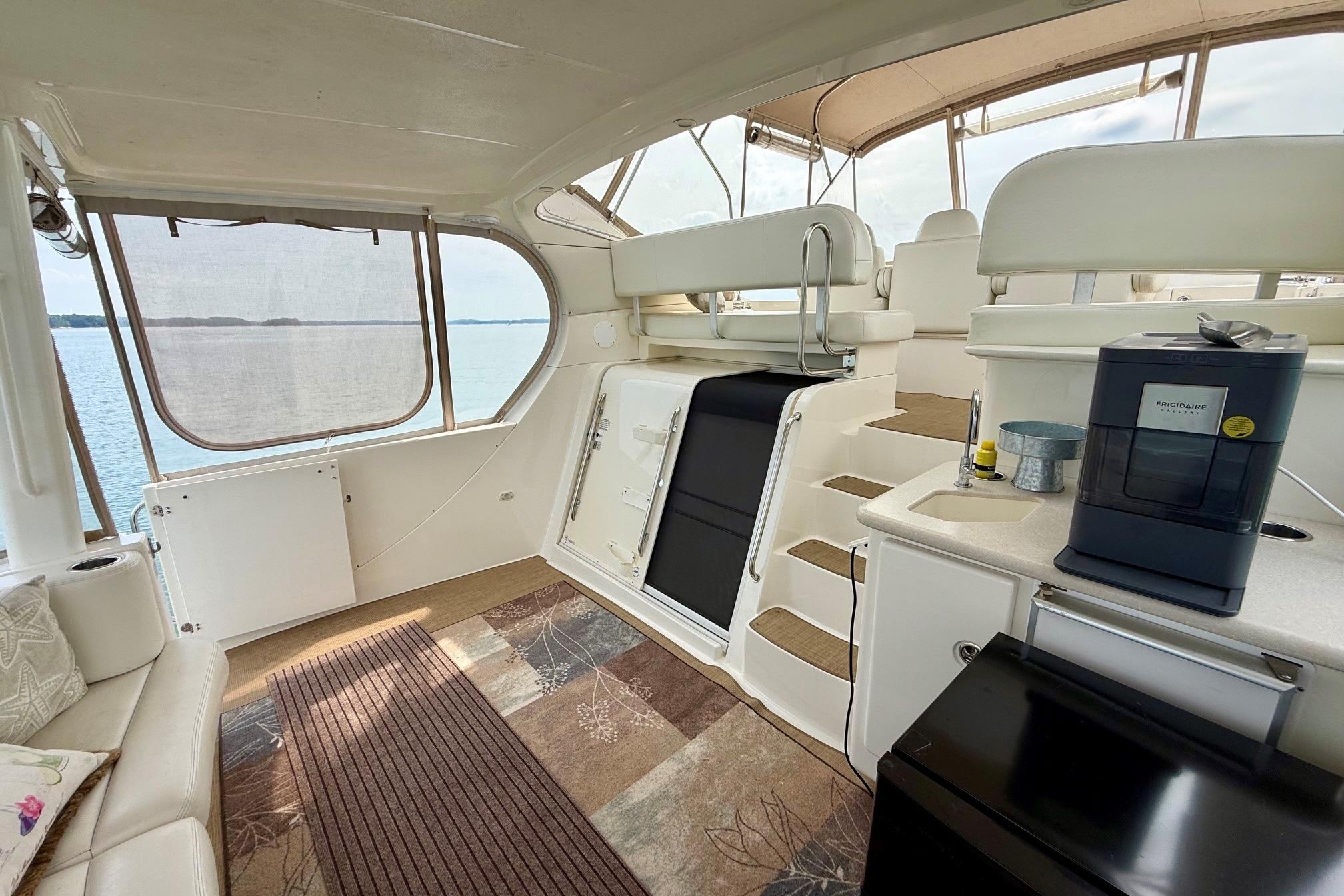 Interior of 2004 Silverton 39 Motor Yacht with seating, stairs, and appliances.