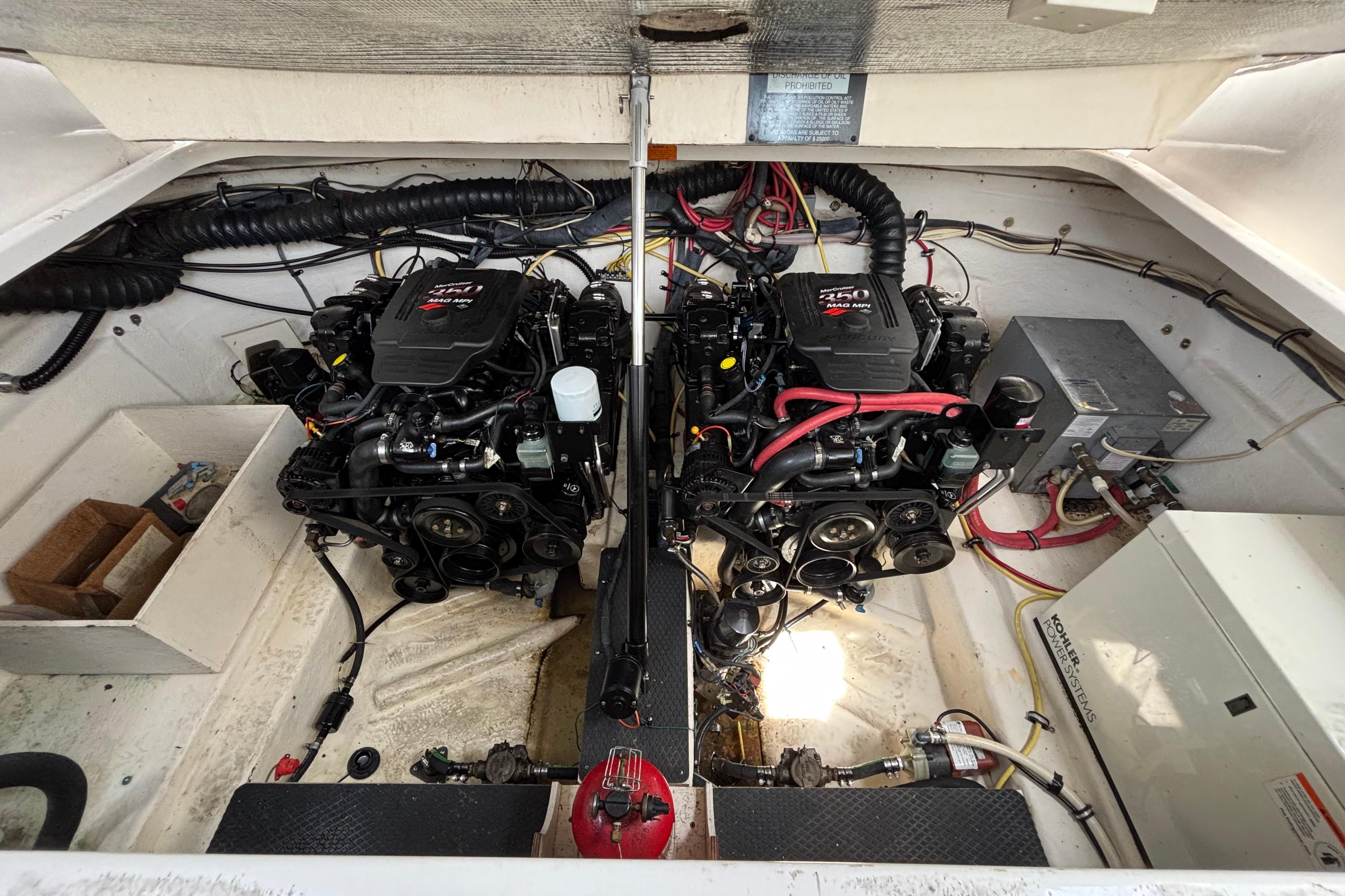 Engine compartment of a 2004 Chaparral Signature 330 boat, featuring dual engines and wiring.