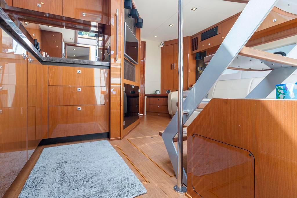 Interior of 2015 Sea Ray 510 Sundancer yacht with wooden cabinetry and modern design.