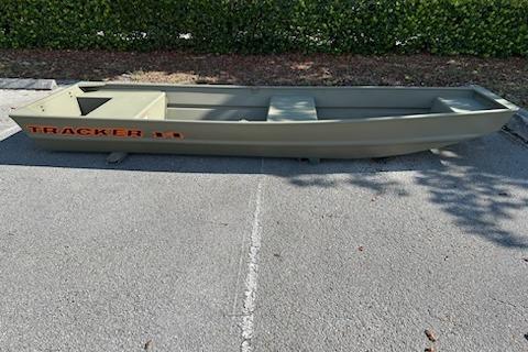 2026 Tracker Grizzly 14 Jon boat in a parking lot, side view.