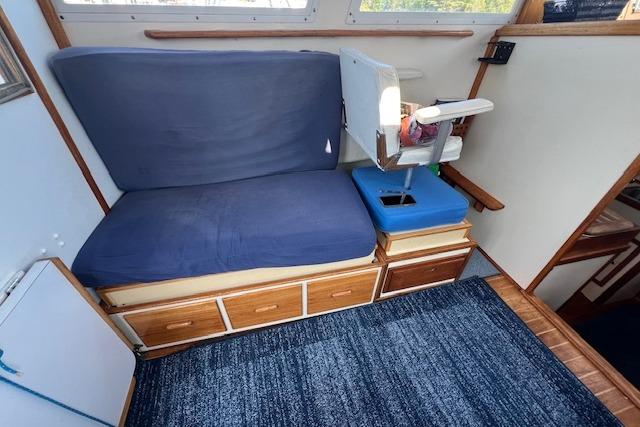 1988 Ellis HARDTOP CRUISER interior with blue seating and wooden storage drawers.