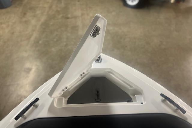 2025 Cobalt CS23 Surf boat storage compartment with open hatch, showcasing interior space.