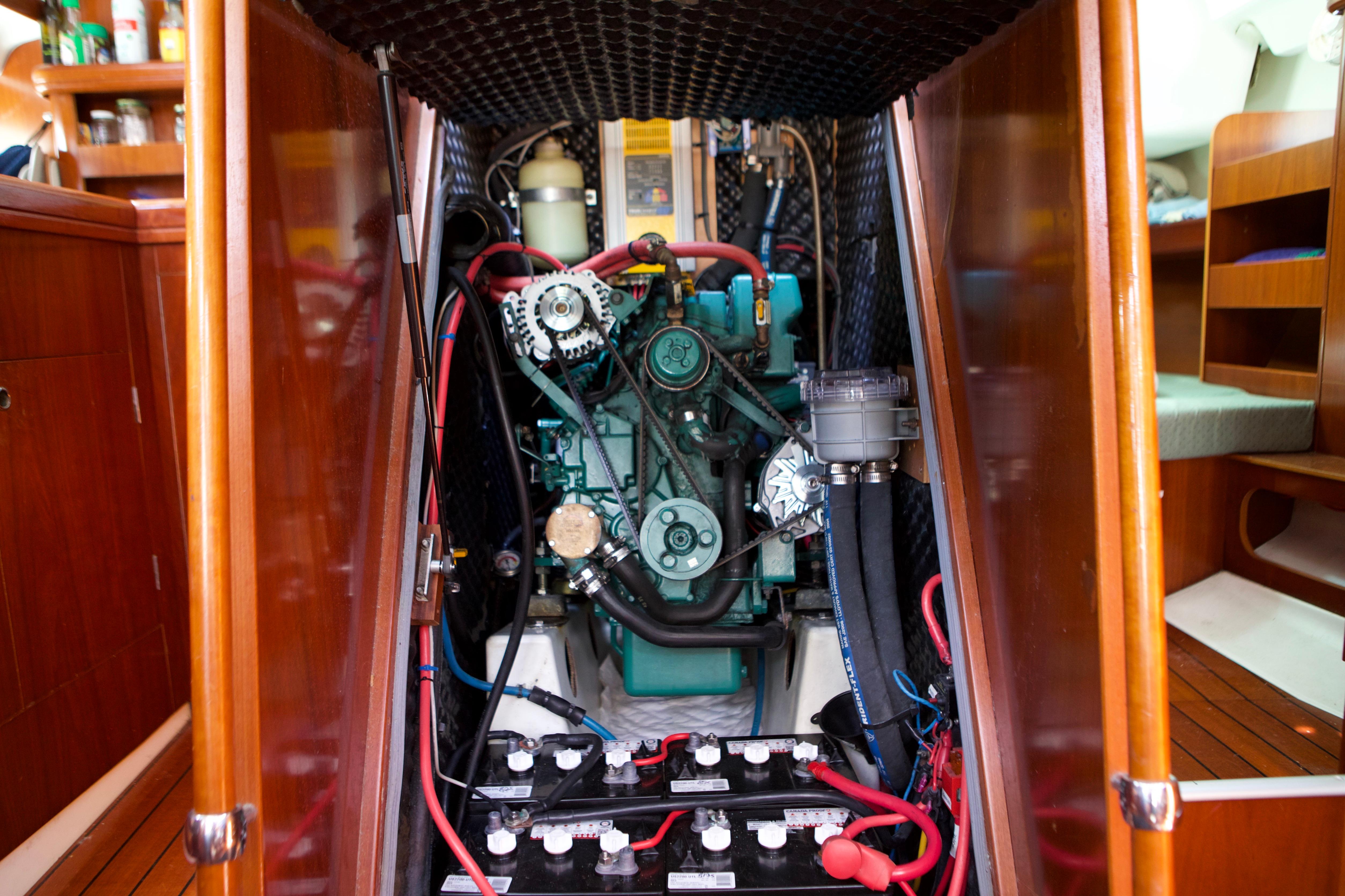 Engine compartment of a 2005 Beneteau 423 sailboat, showcasing mechanical components and batteries.