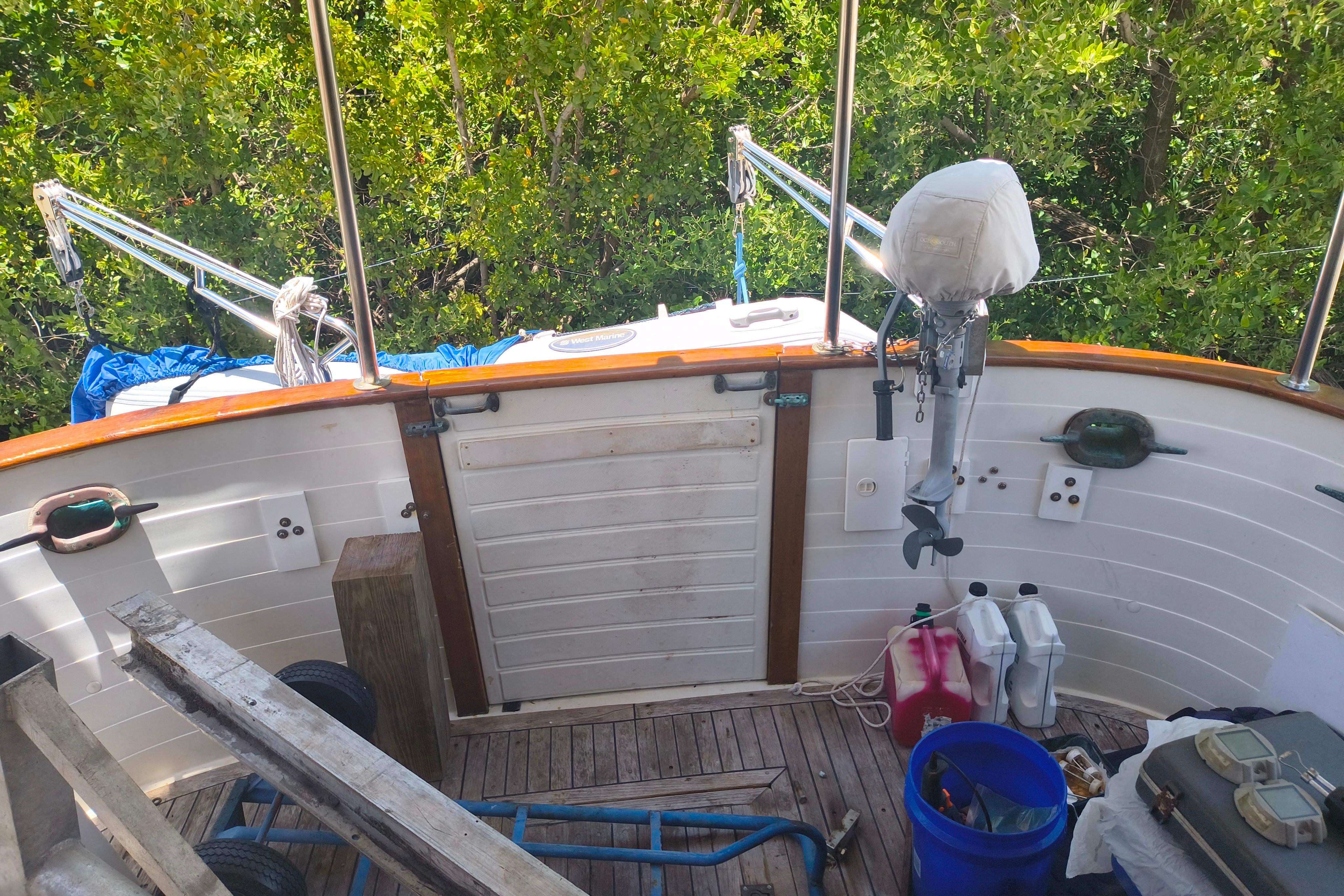 1984 Kadey-Krogen Manatee boat deck with equipment and greenery in the background.