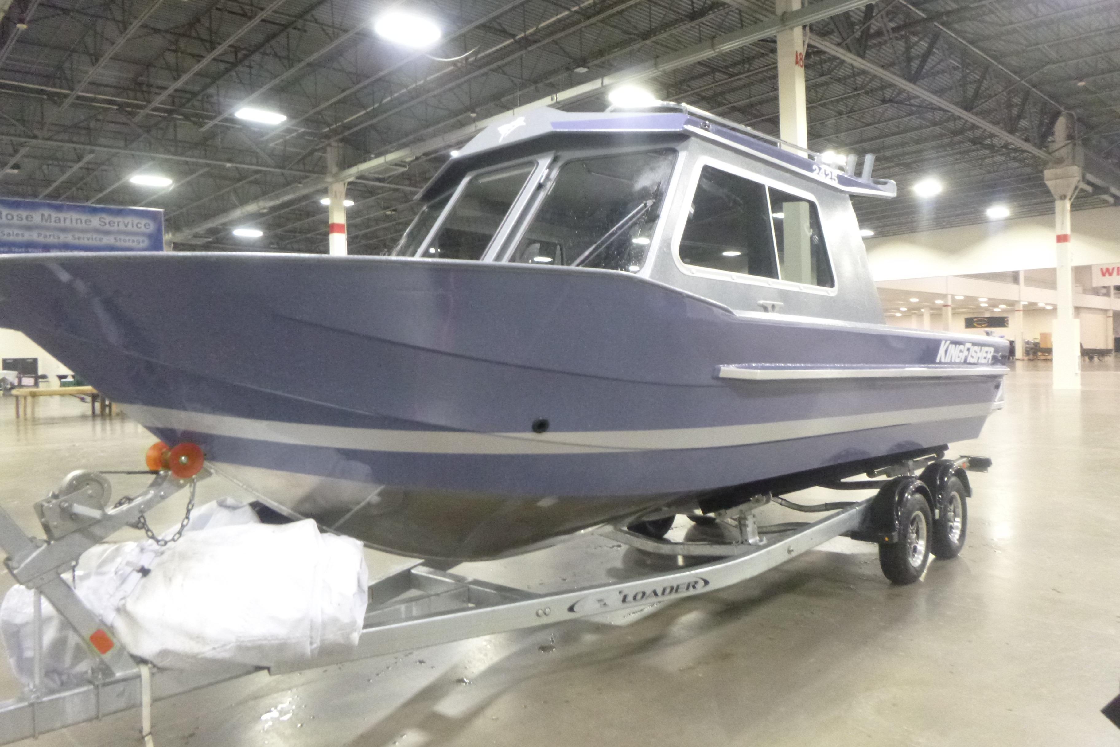 2026 KingFisher 2425 Escape HT boat on trailer in indoor showroom.