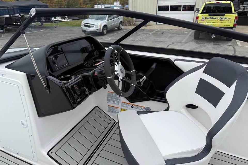 Interior view of 2026 Yamaha Boats 195S, featuring sleek dashboard and modern steering wheel.