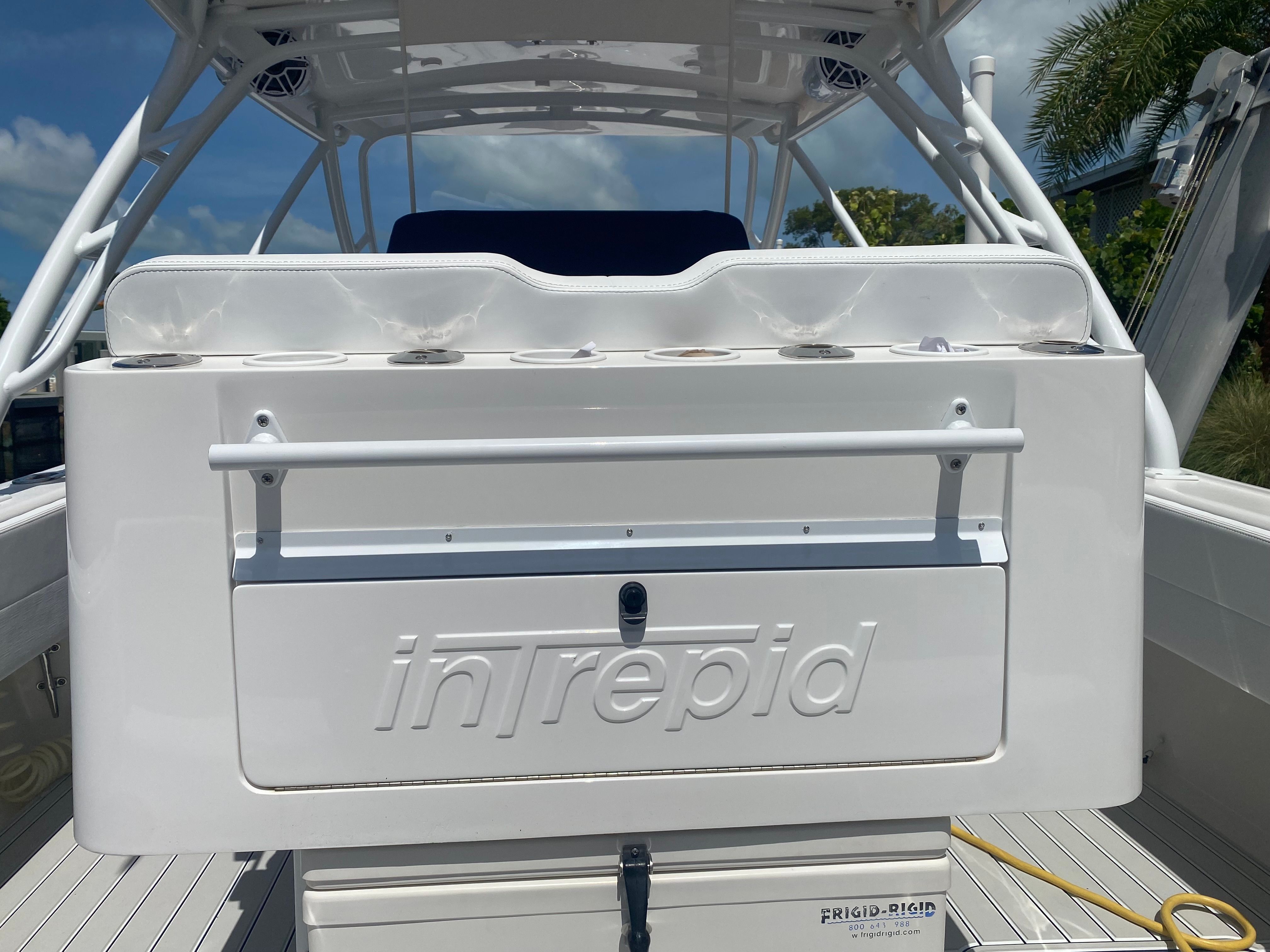 The image shows the stern of a 2011 Intrepid 37 boat with a white storage area.