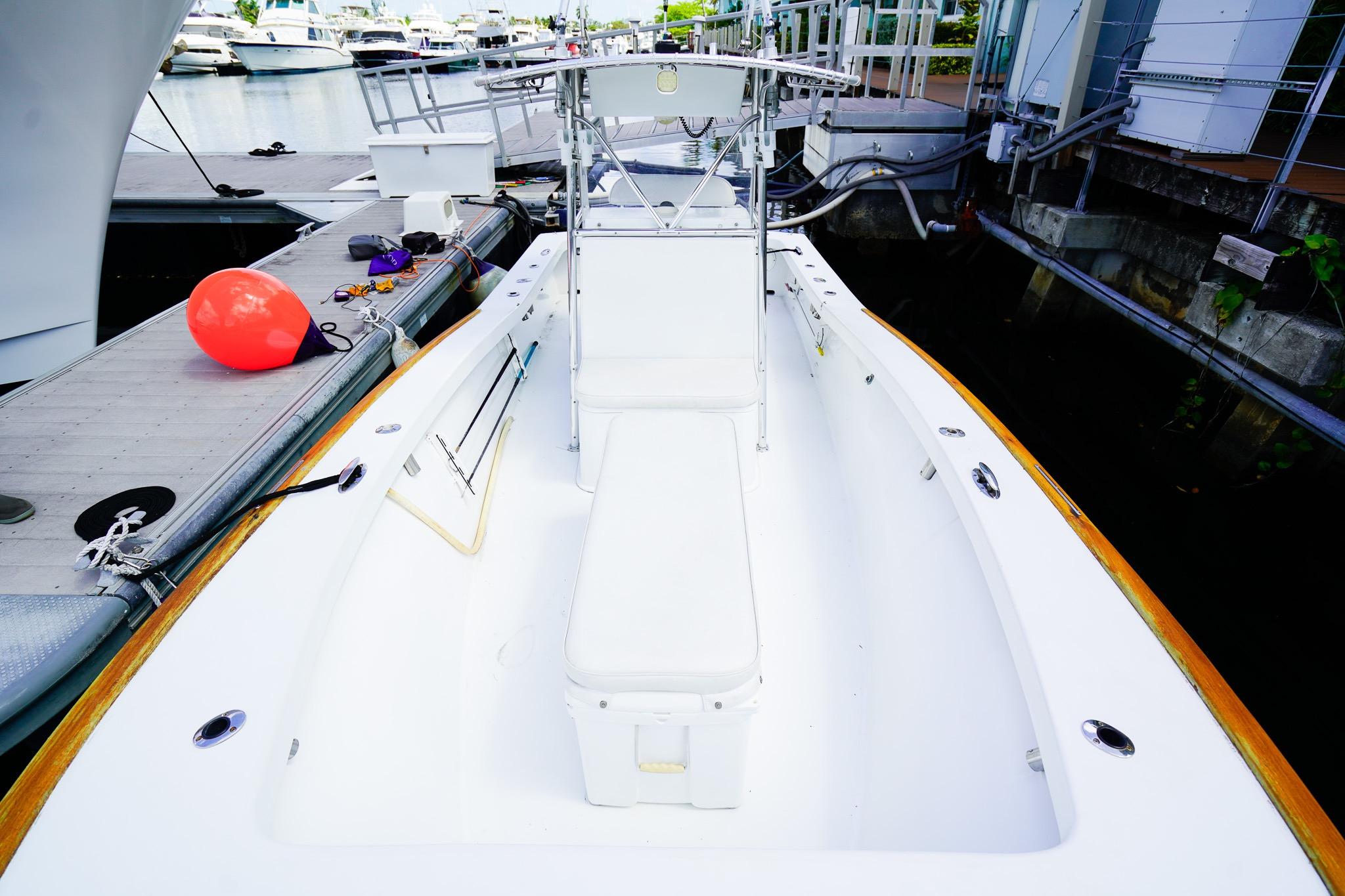 1977 Scarborough 27 CC boat docked, featuring a clean white deck and seating area.
