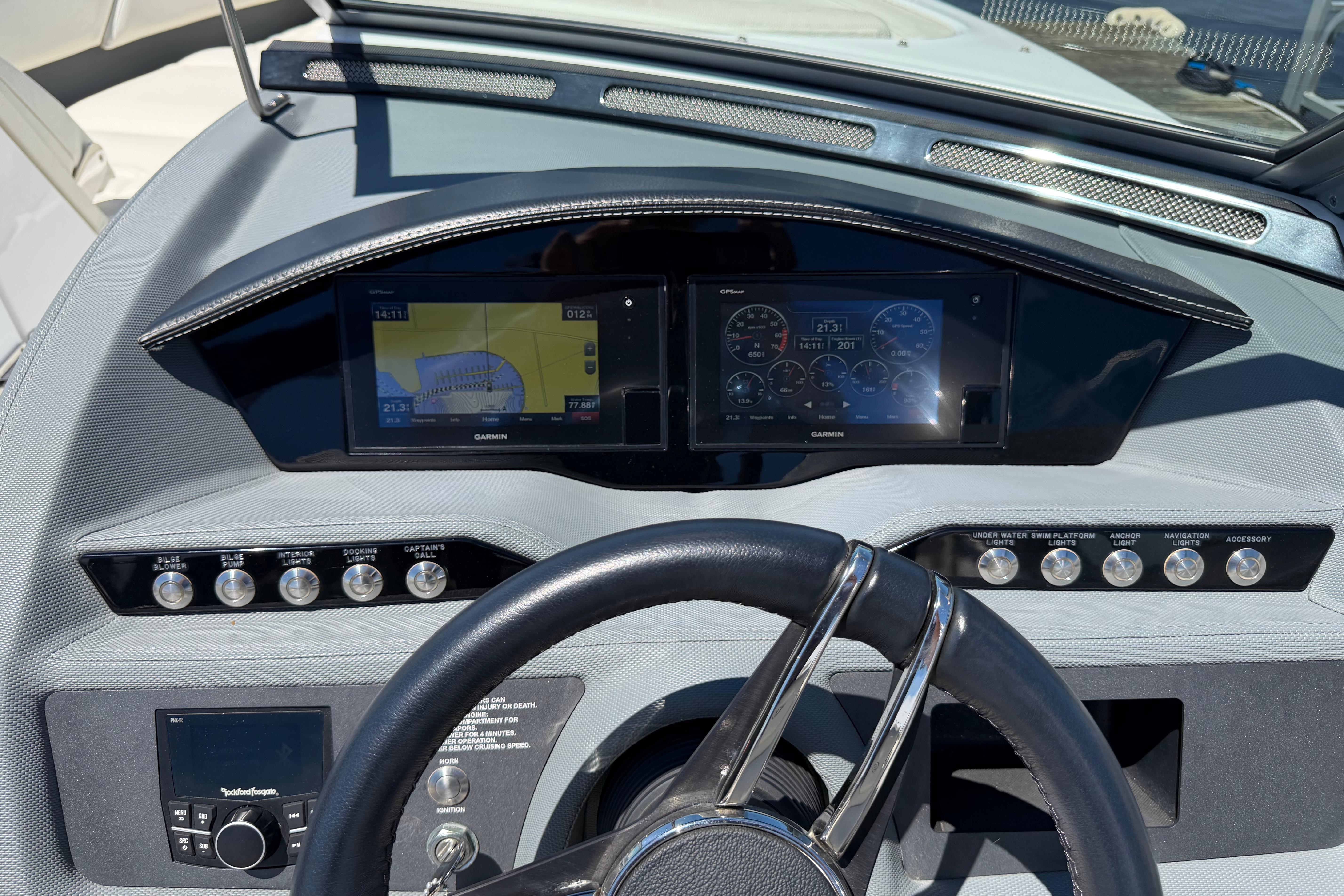 2020 Cobalt R3 boat dashboard with Garmin navigation displays and control buttons.