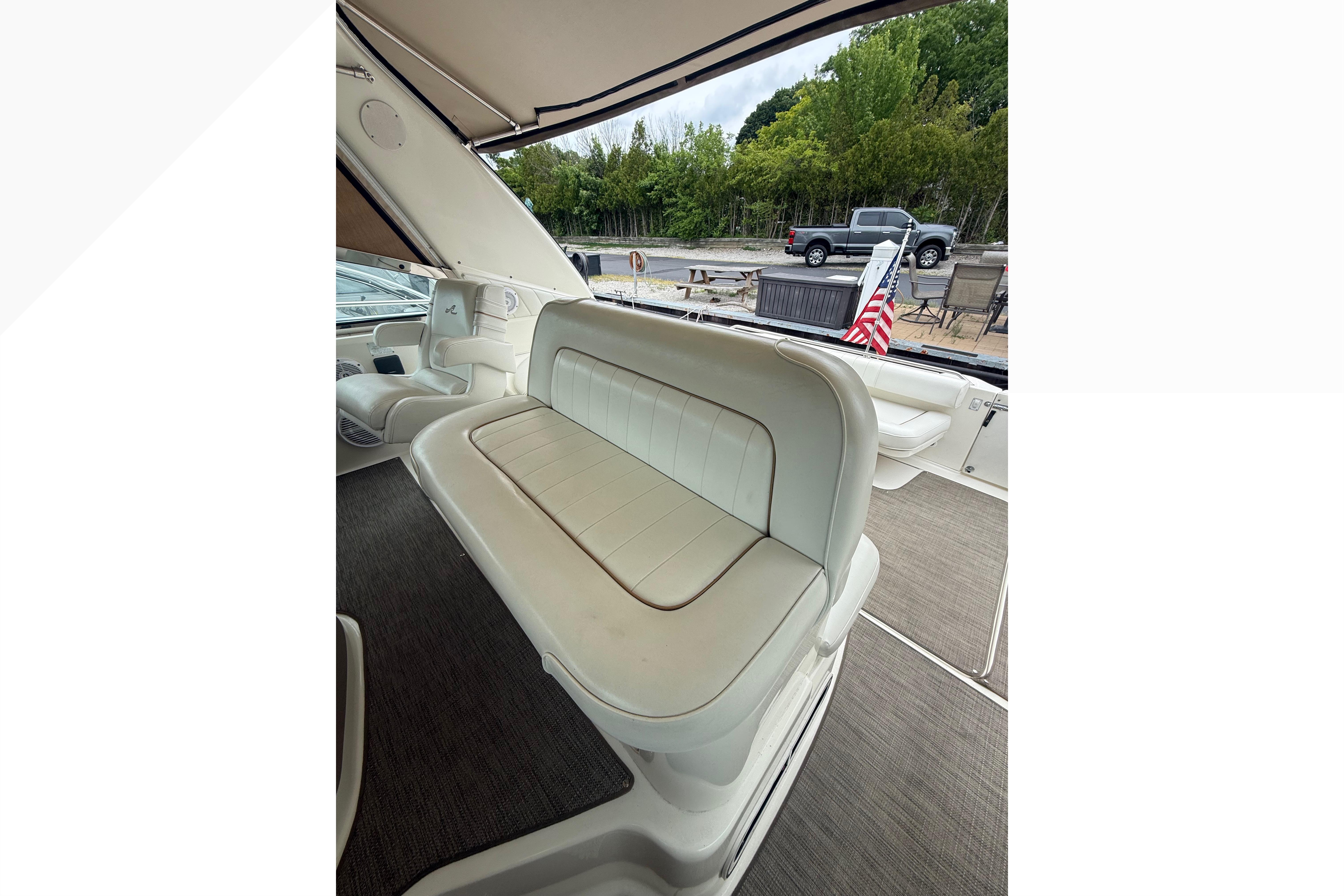 1998 Sea Ray Sundancer 400 interior with white seating and American flag.