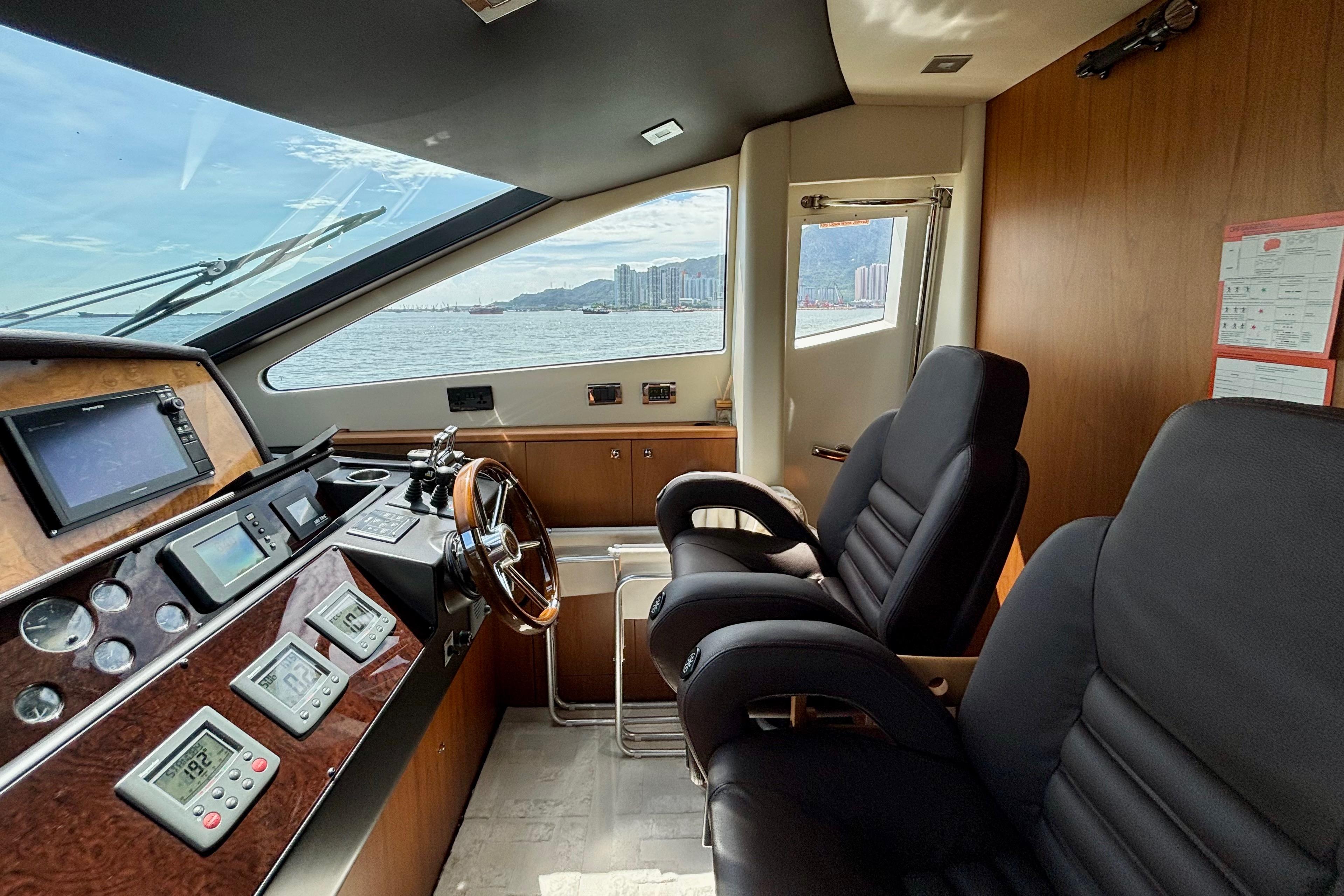 Interior helm of 2011 Sunseeker 88 Yacht with modern controls and panoramic view.