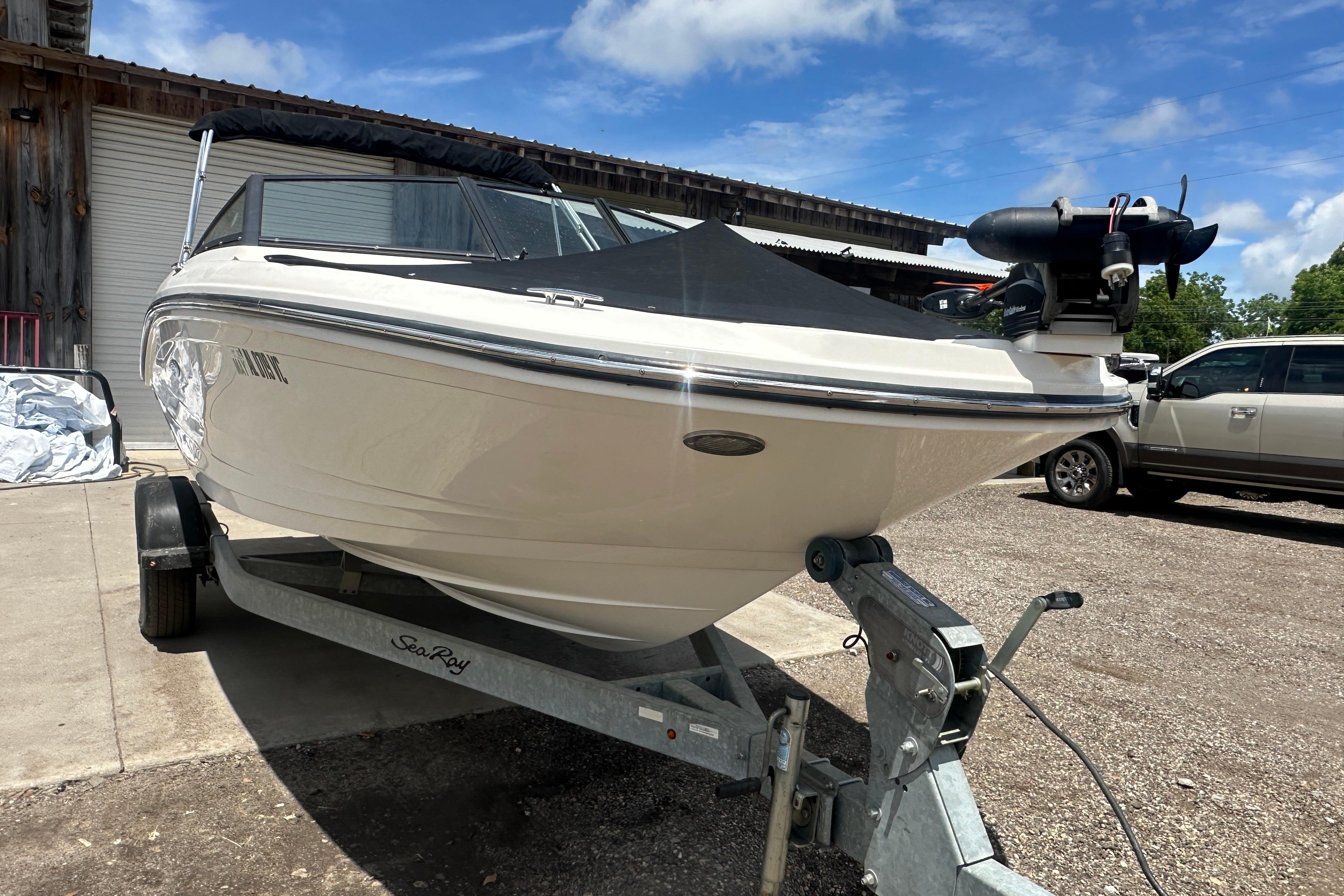 2017 Sea Ray SPX 190 Outboard boat on trailer under blue sky.
