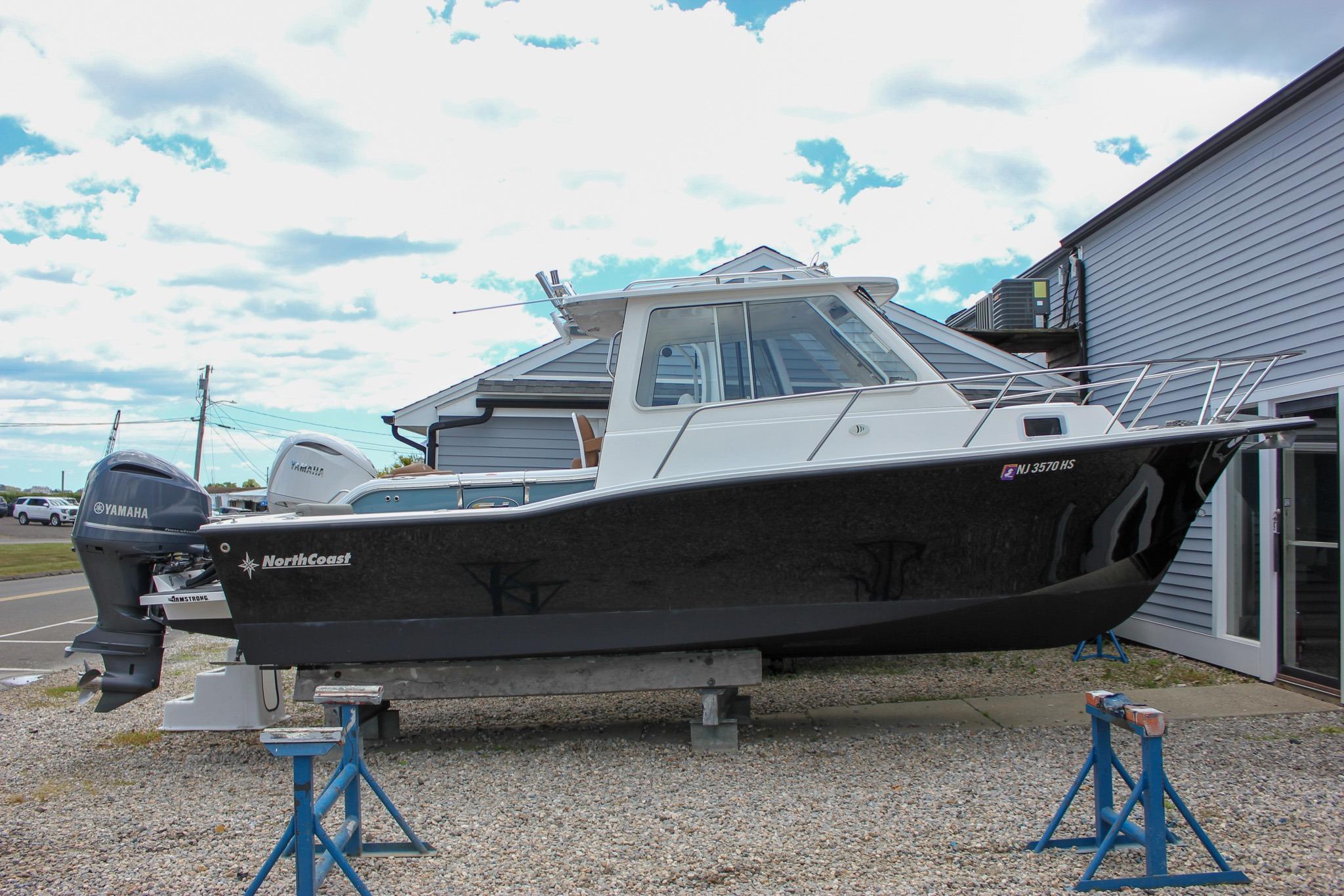 2022 NorthCoast 235 Cabin boat on stands, featuring Yamaha outboard motor.