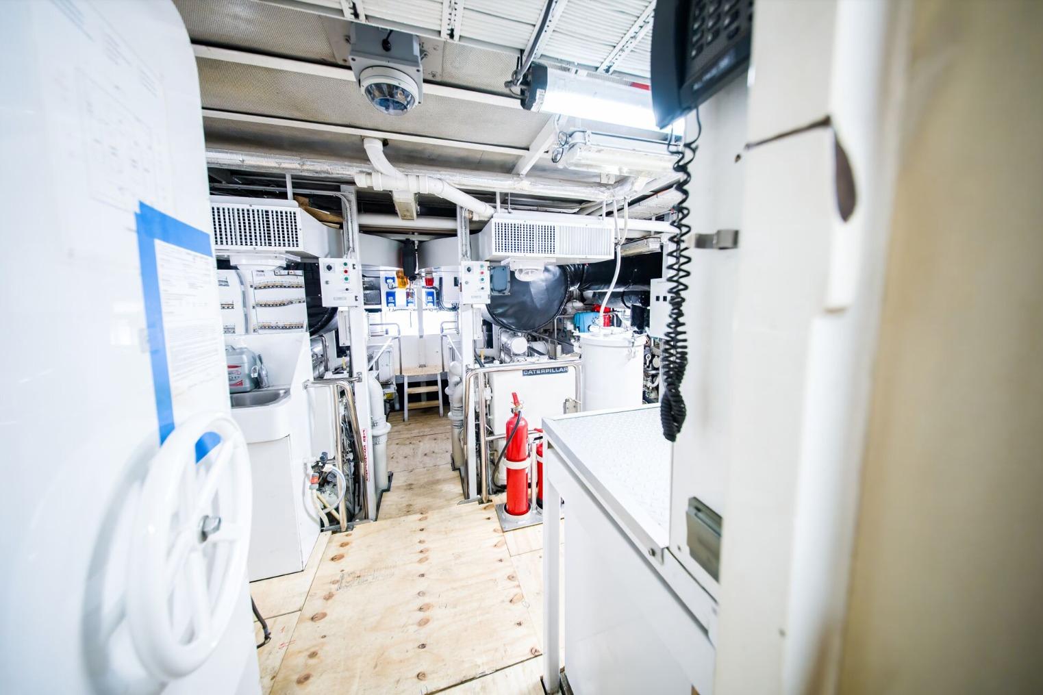 Engine room of a 1988 Feadship Twin Screw Diesel Yacht, showcasing machinery and equipment.