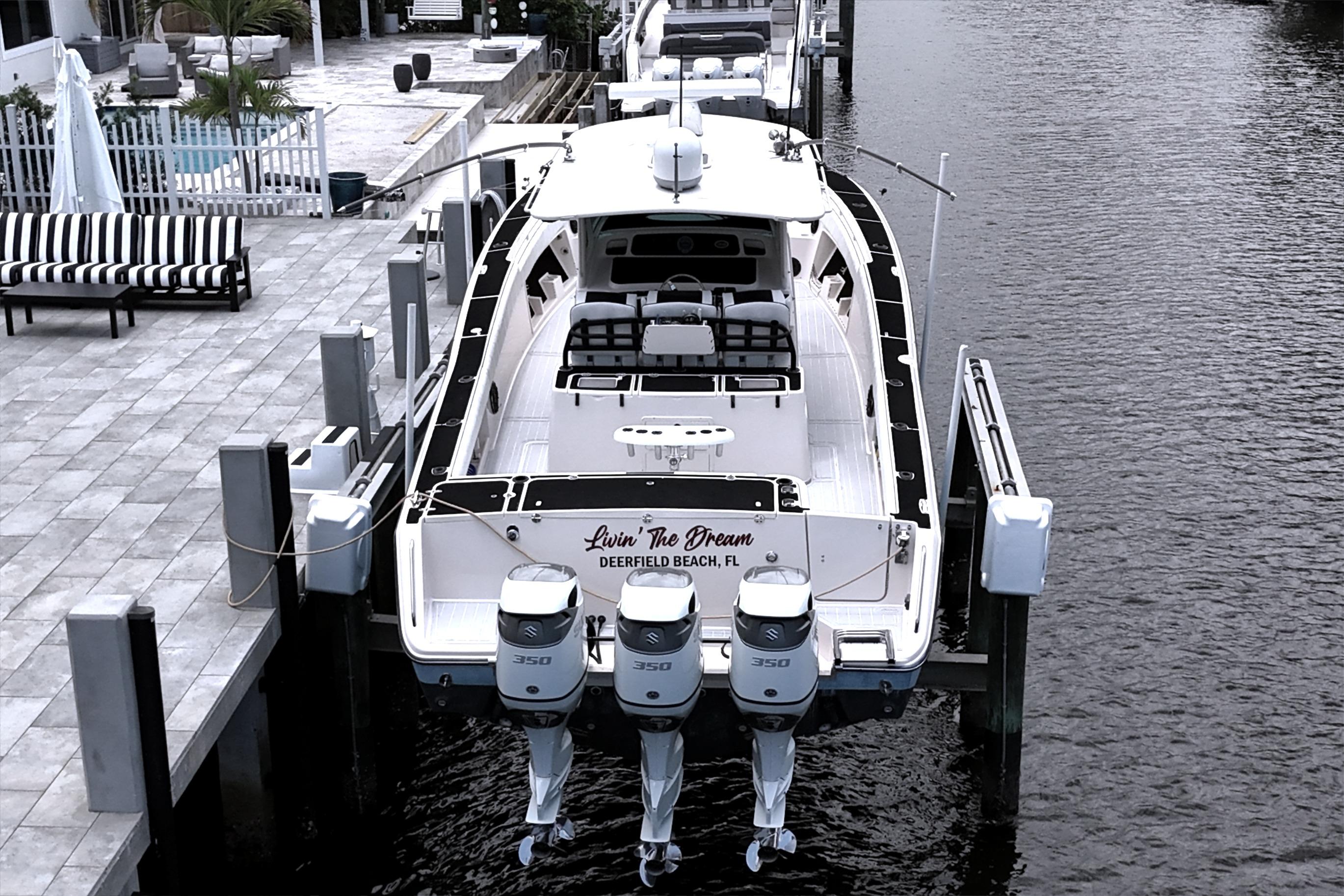 2010 Grady-White Canyon 366 boat docked, featuring triple 350 horsepower engines.