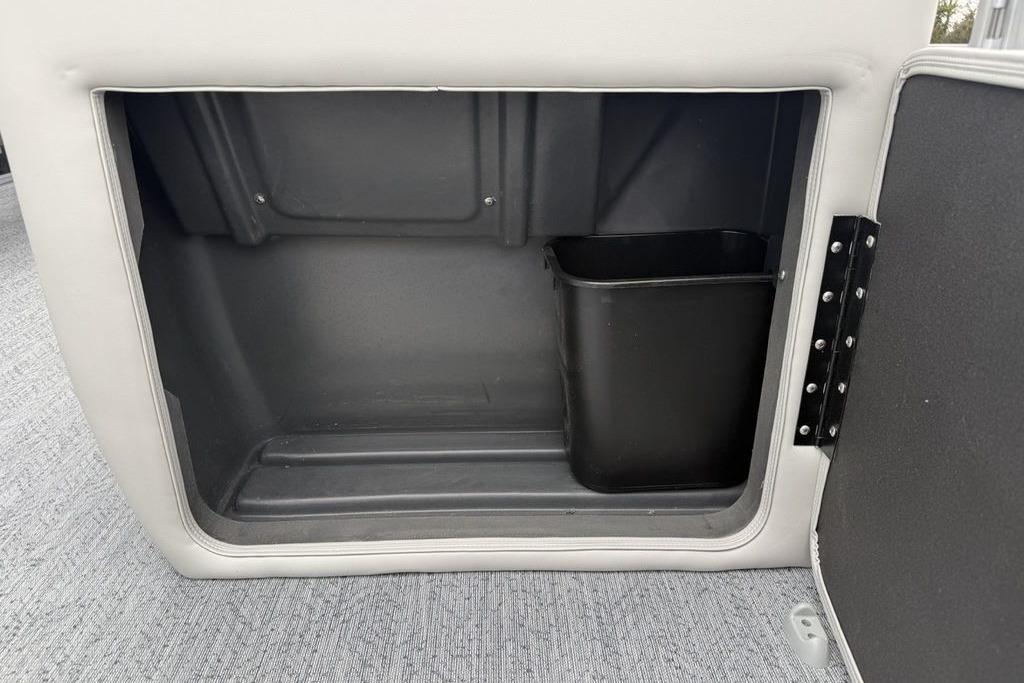 Storage compartment with trash bin in 2026 Sun Tracker Fishin' Barge 20 DLX boat.
