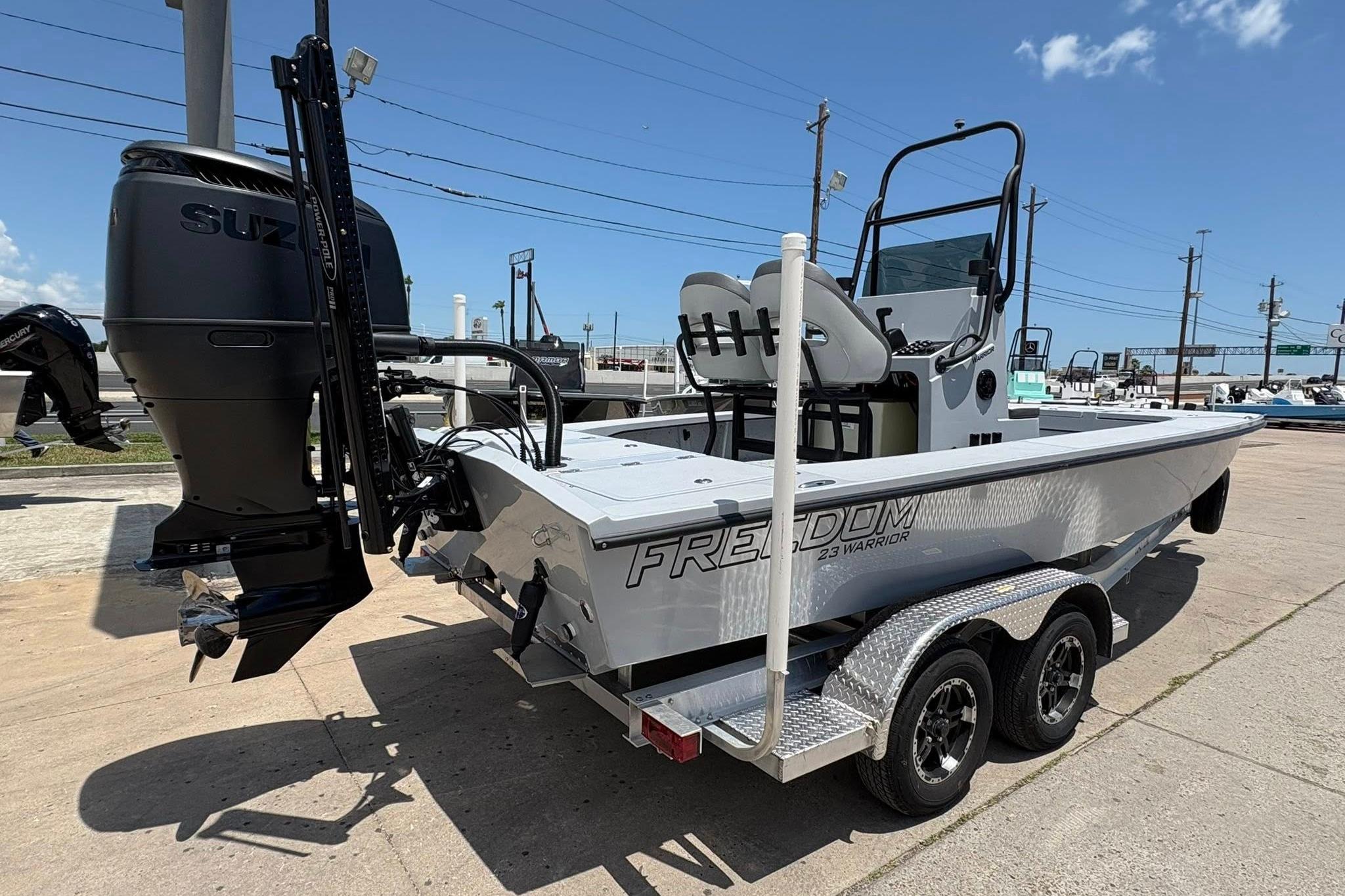 2026 Freedom Boats 23' Warrior on trailer, featuring Suzuki outboard motor.