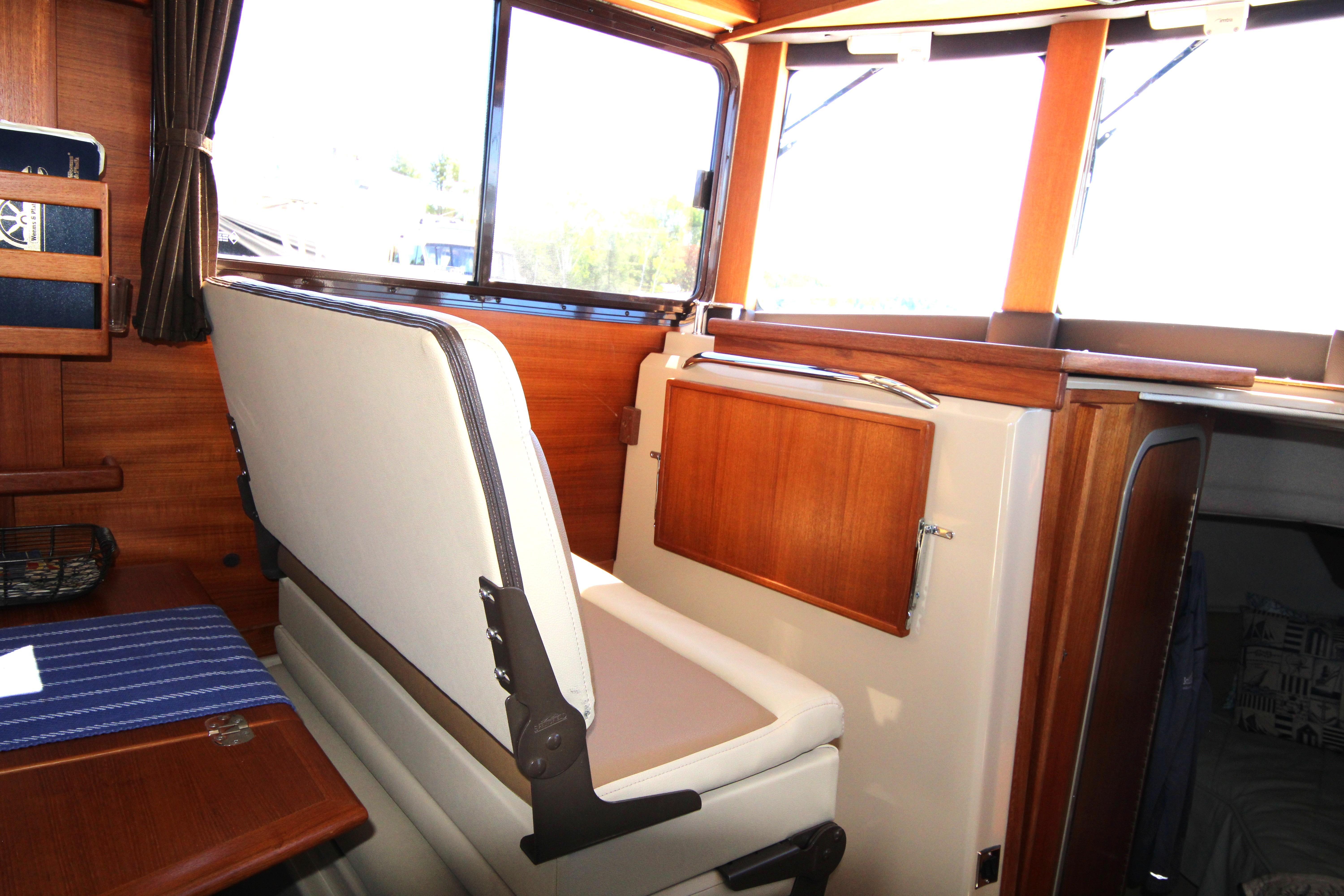 Interior of 2013 Ranger Tugs R-31 CB with wooden accents and seating.