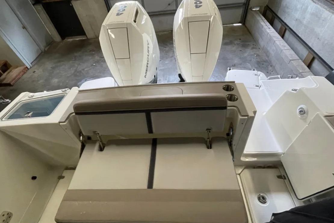 2025 Boston Whaler 330 Vantage boat interior with dual engines and seating area.