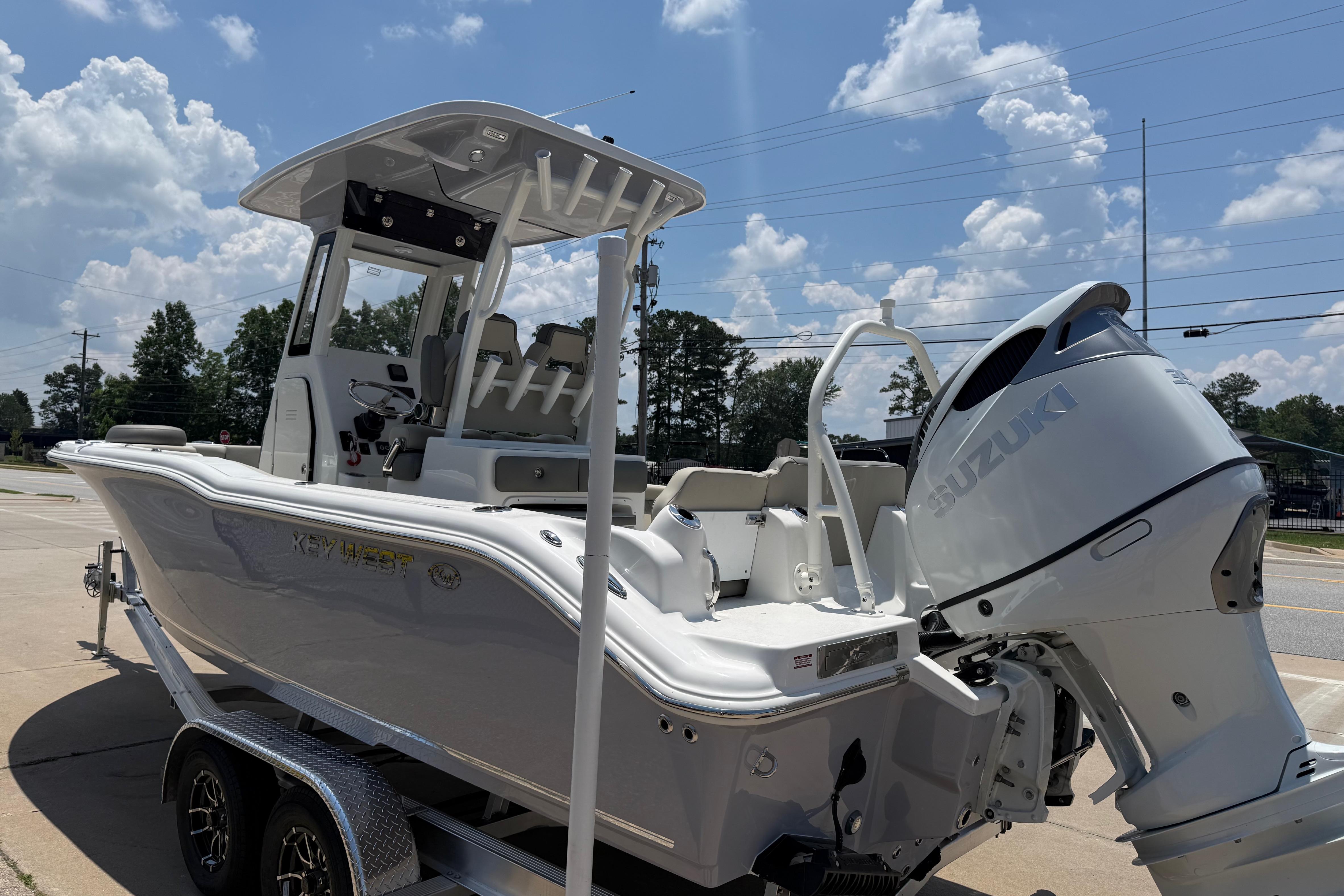 2027 Key West 249 FS boat with Suzuki engine on trailer under blue sky.