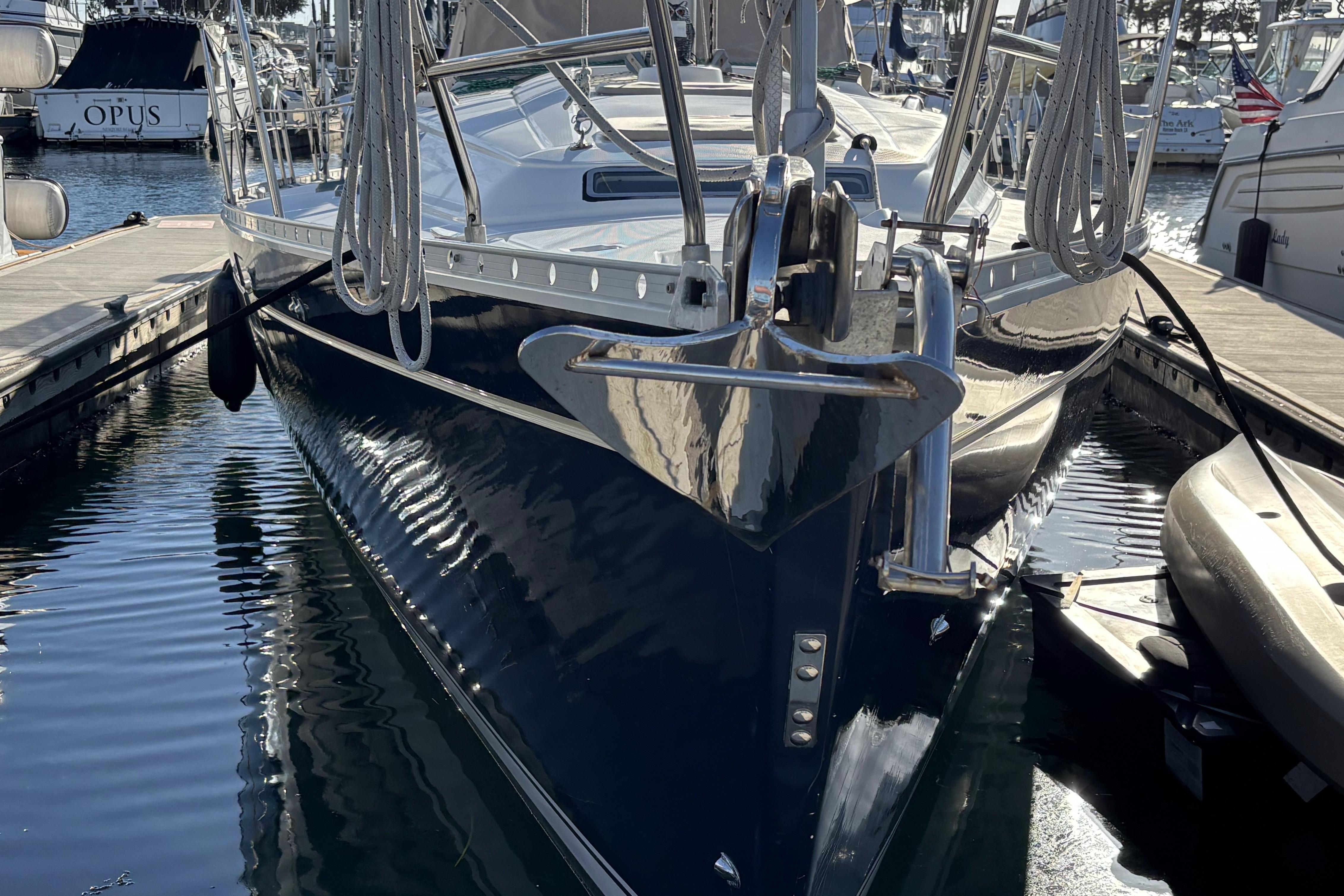 1997 Beneteau Oceanis 400 sailboat docked in marina, reflecting on water.