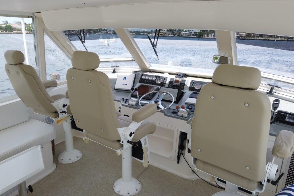 1999 Viking Cockpit Motoryacht helm with beige seats and navigation controls.