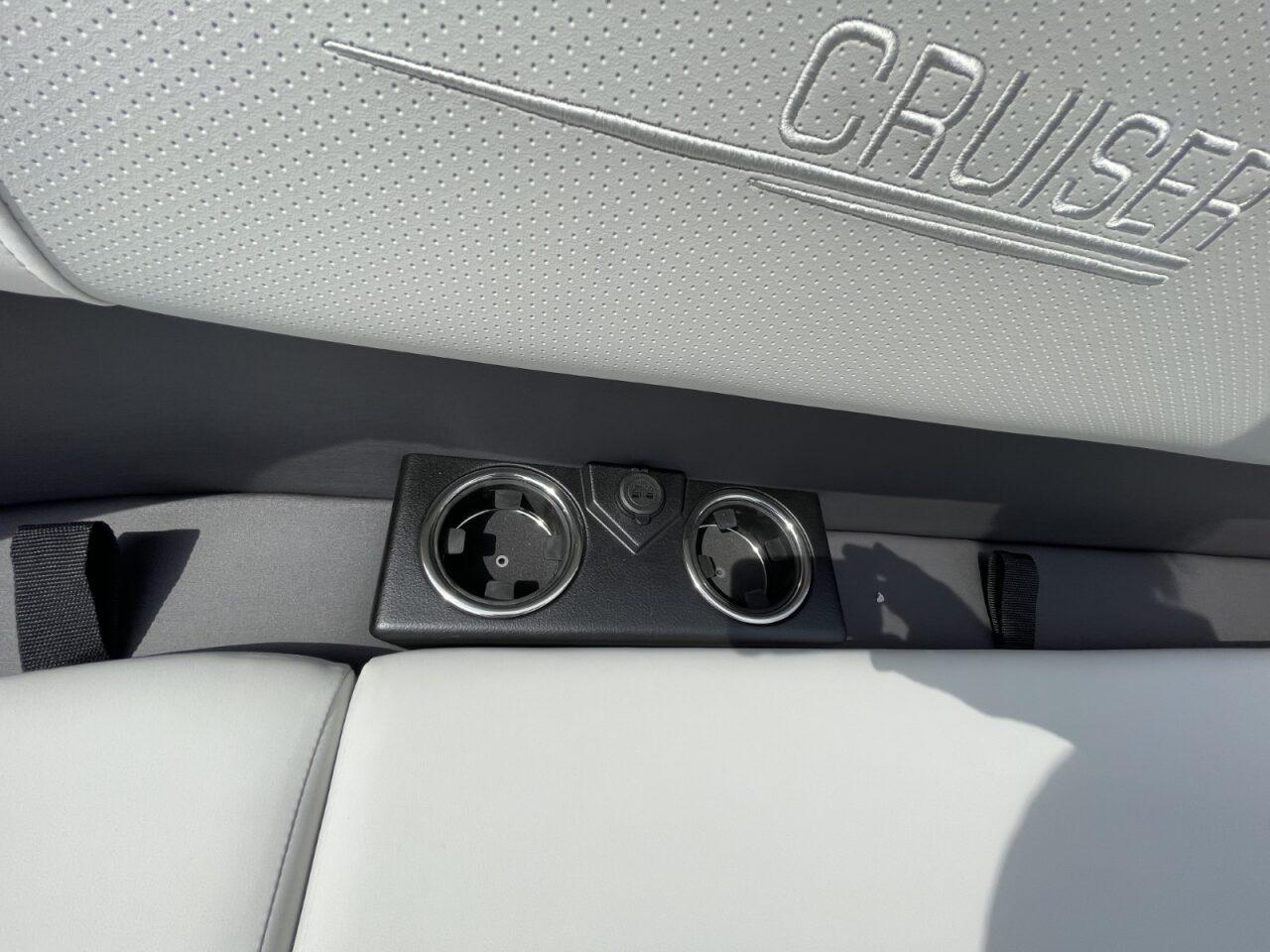 2026 Harris Cruiser 230 interior with cup holders and embossed seat design.