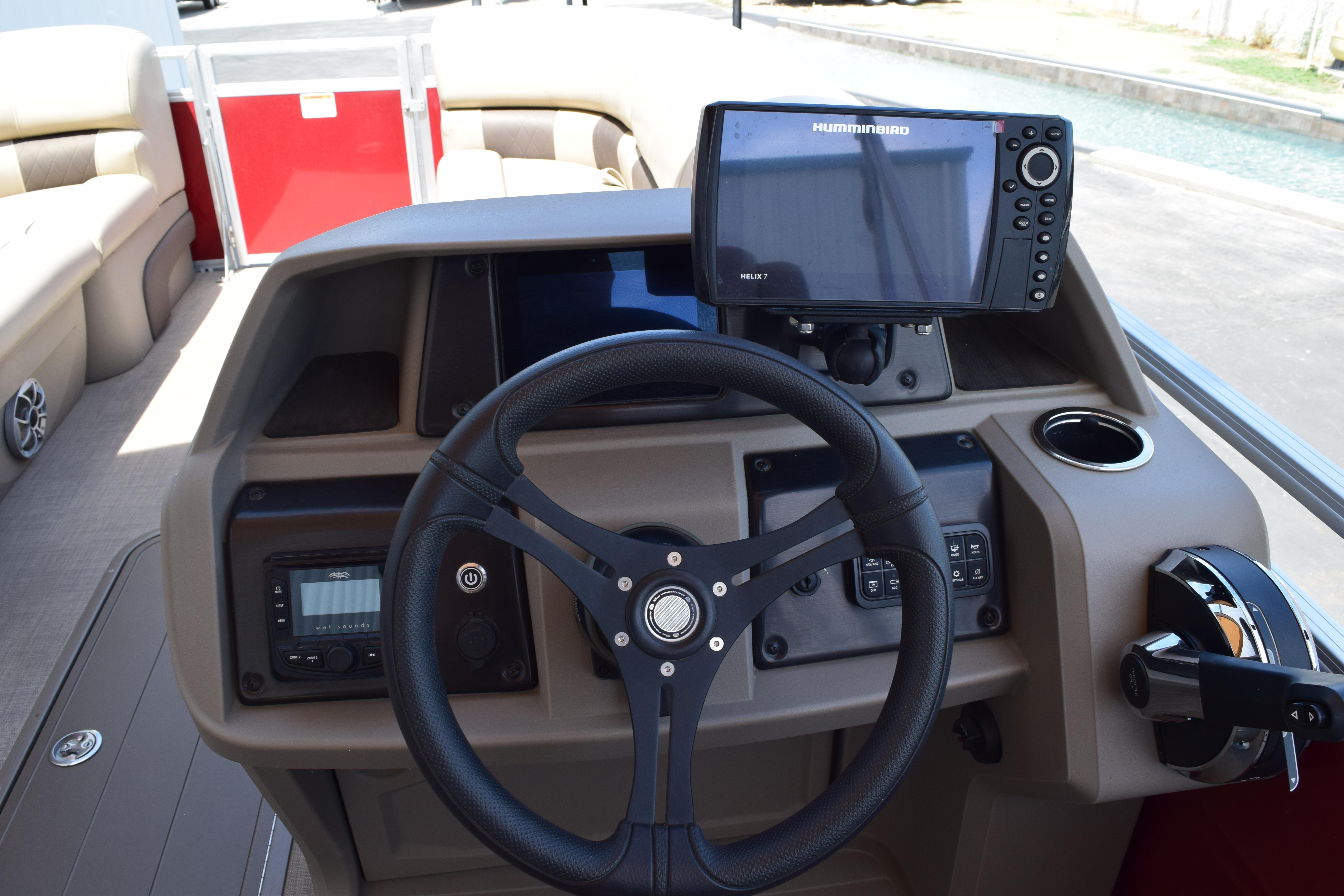 2025 Sun Tracker Party Barge 22 XP3 helm with steering wheel and navigation system.