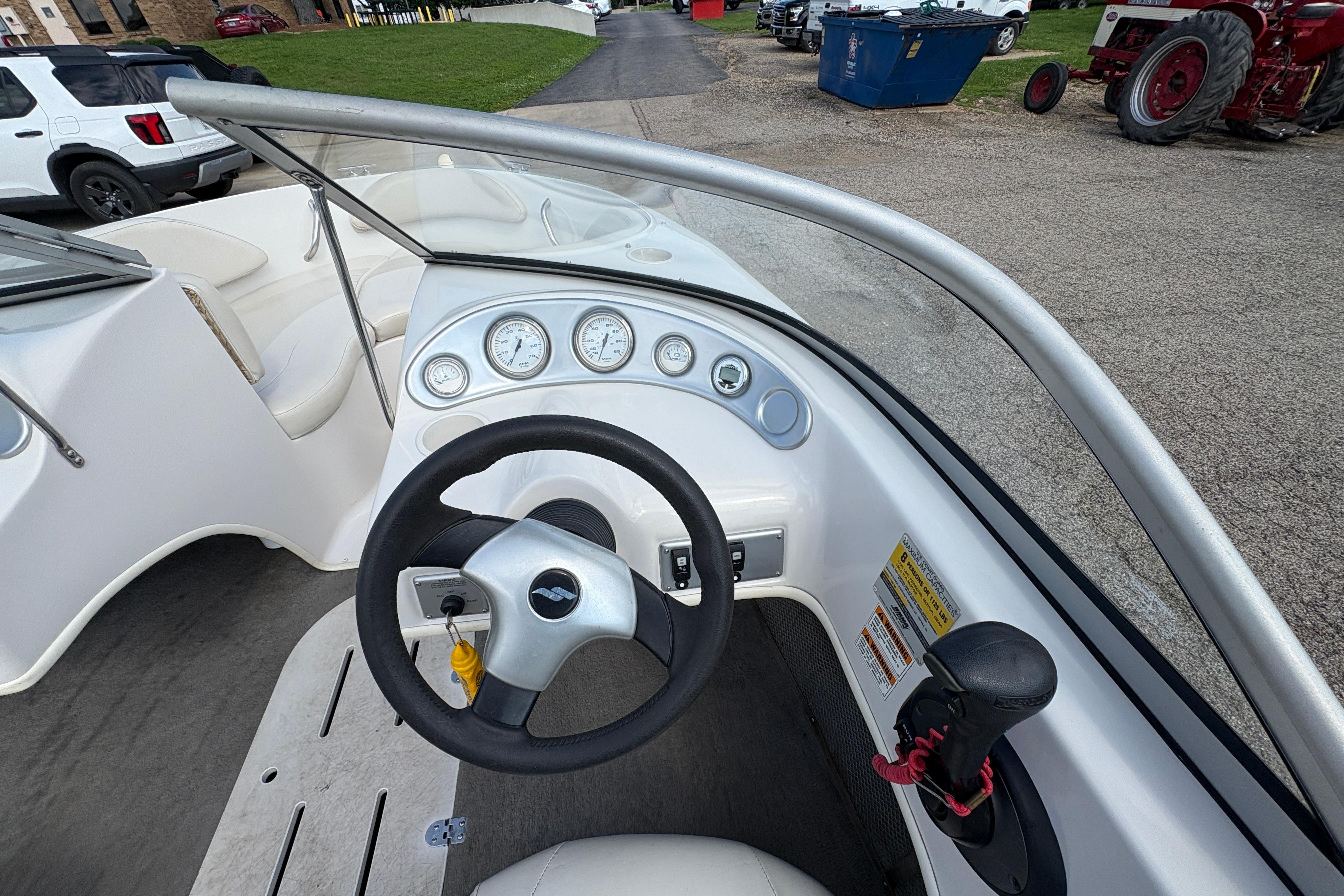 Steering console of a 2005 Starcraft C-Star 1700 OB boat with gauges and controls.