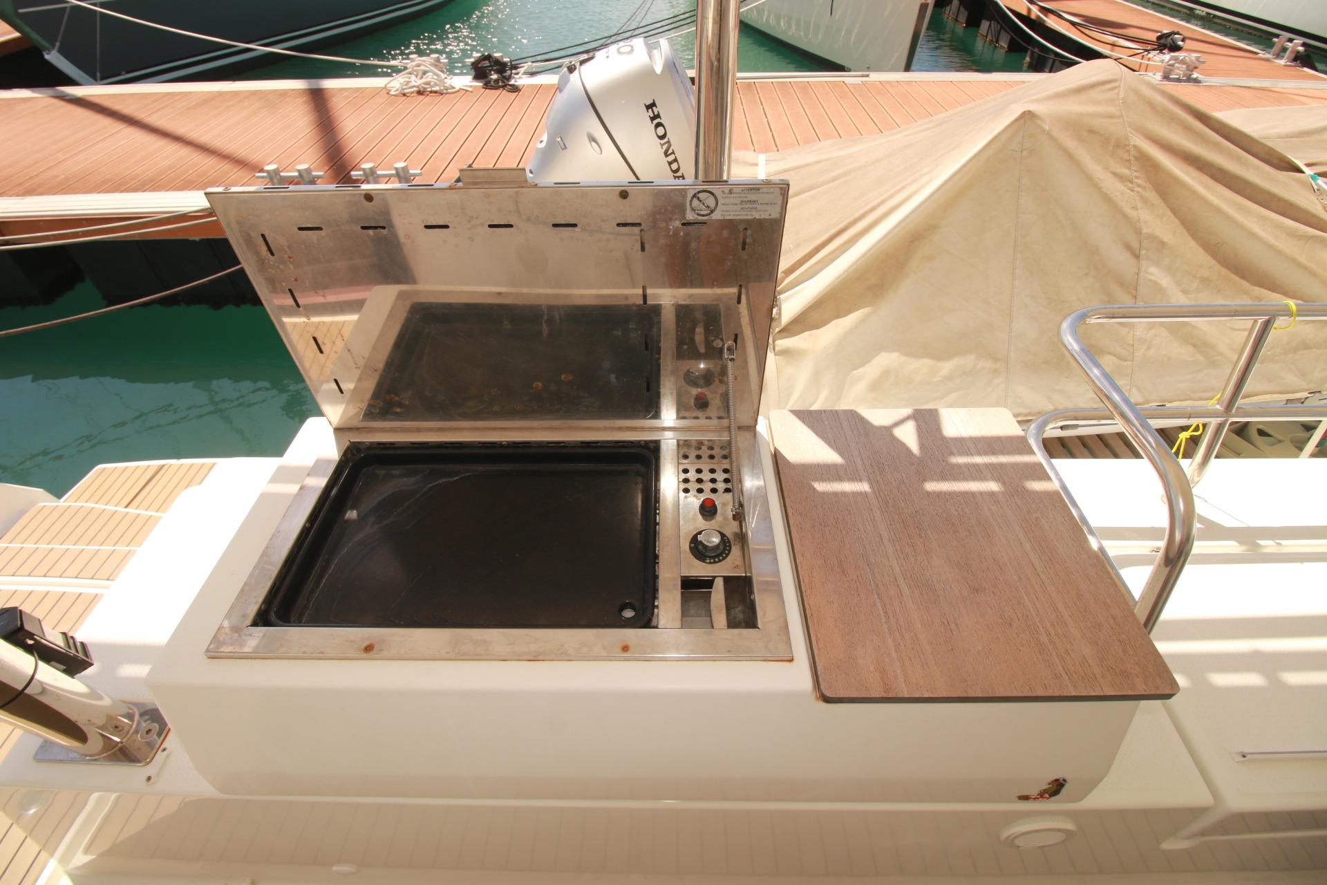 Outdoor grill on 2022 Fountaine Pajot Elba 45 Catamaran, docked at marina.