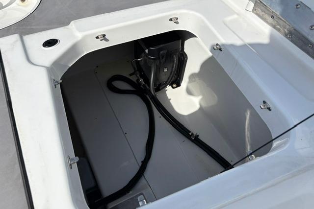 2024 Tahoe T21 boat storage compartment with cables and equipment.
