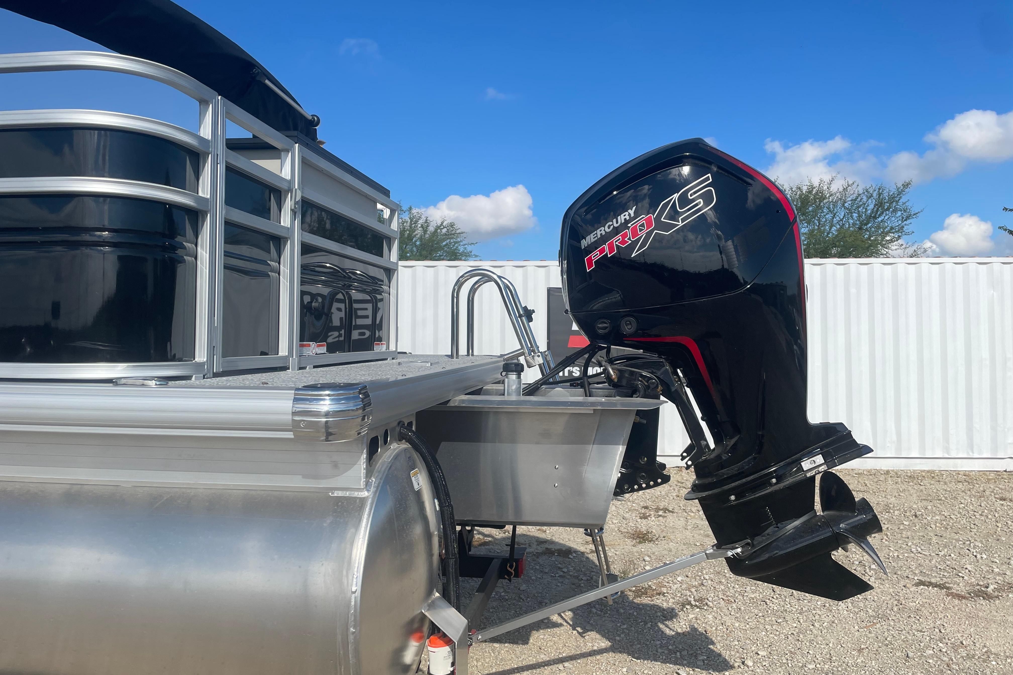 2026 Sun Tracker Fishin' Barge 20 DLX with Mercury Pro XS outboard motor.