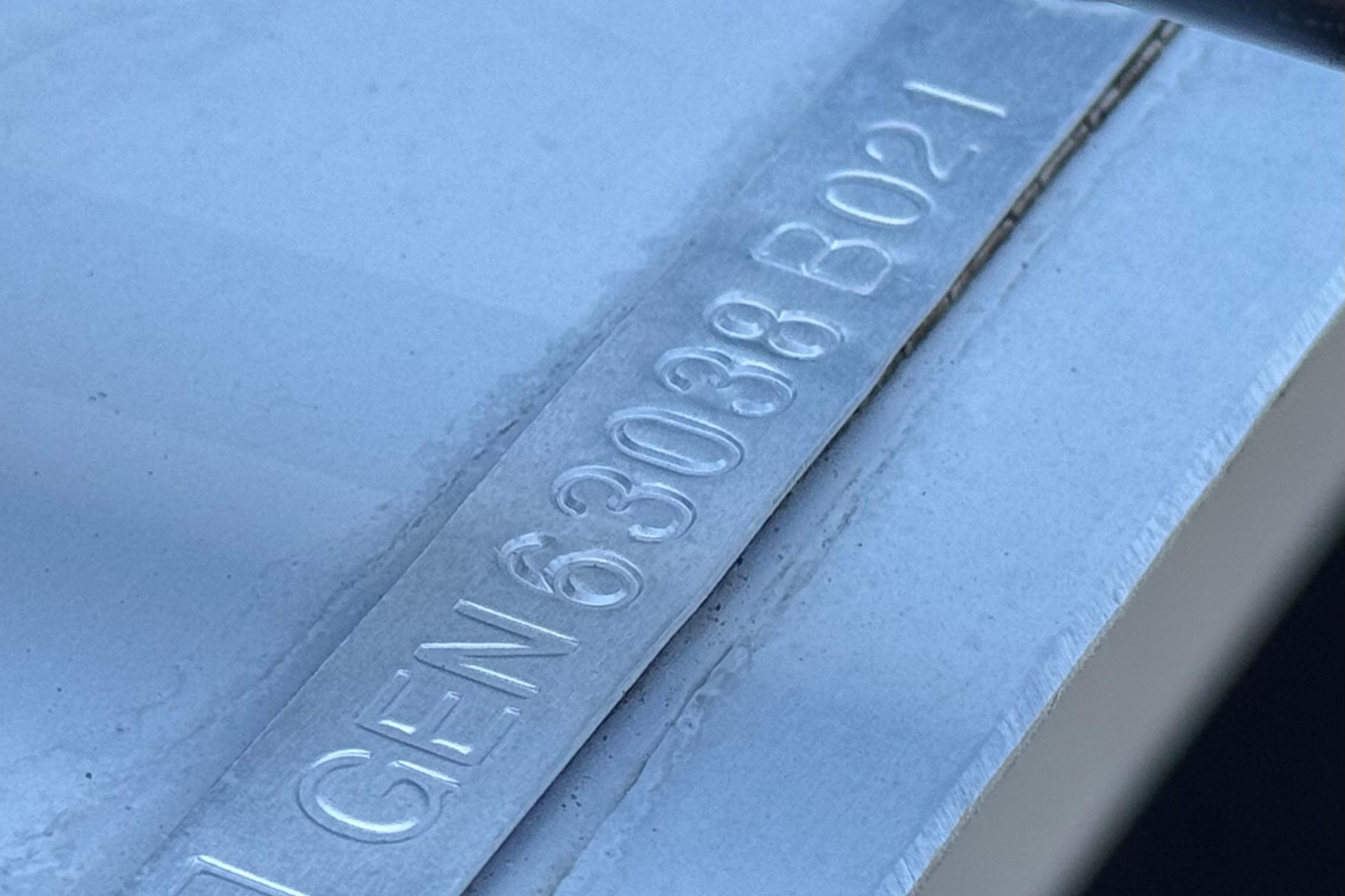 Close-up of a metal plate with embossed serial number on a 2021 SunCatcher Select 20RCX.